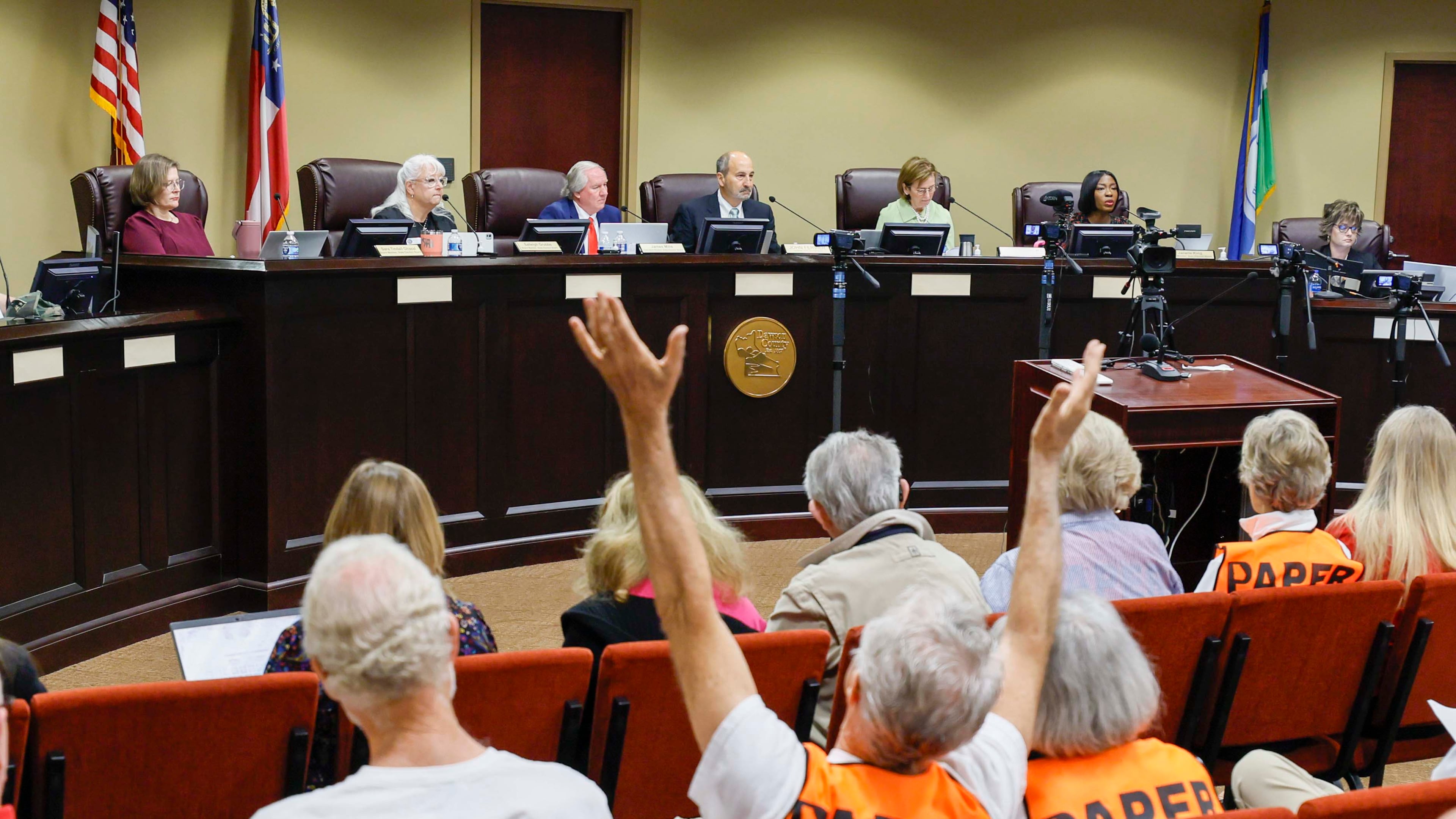 A supporter of paper ballots reacts as board members listen during a State Election Board meeting at Dawson County Government Center on Wednesday, April 15, 2026. (Miguel Martinez/AJC)