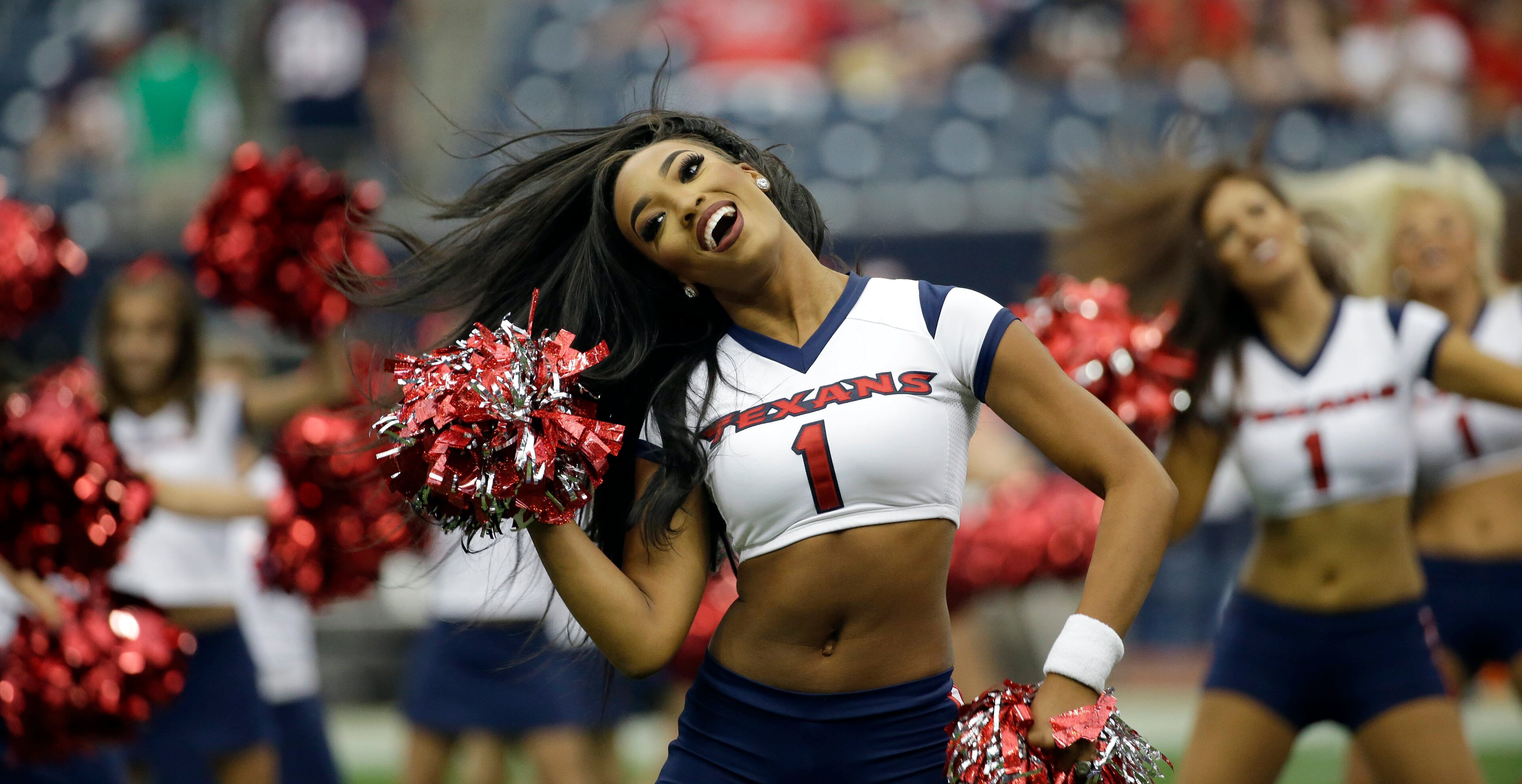 A Houston Texans cheerleader performs before an NFL preseason football game against the Atlanta Falcons Saturday, Aug. 16, 2014, in Houston. (AP Photo/David J. Phillip)