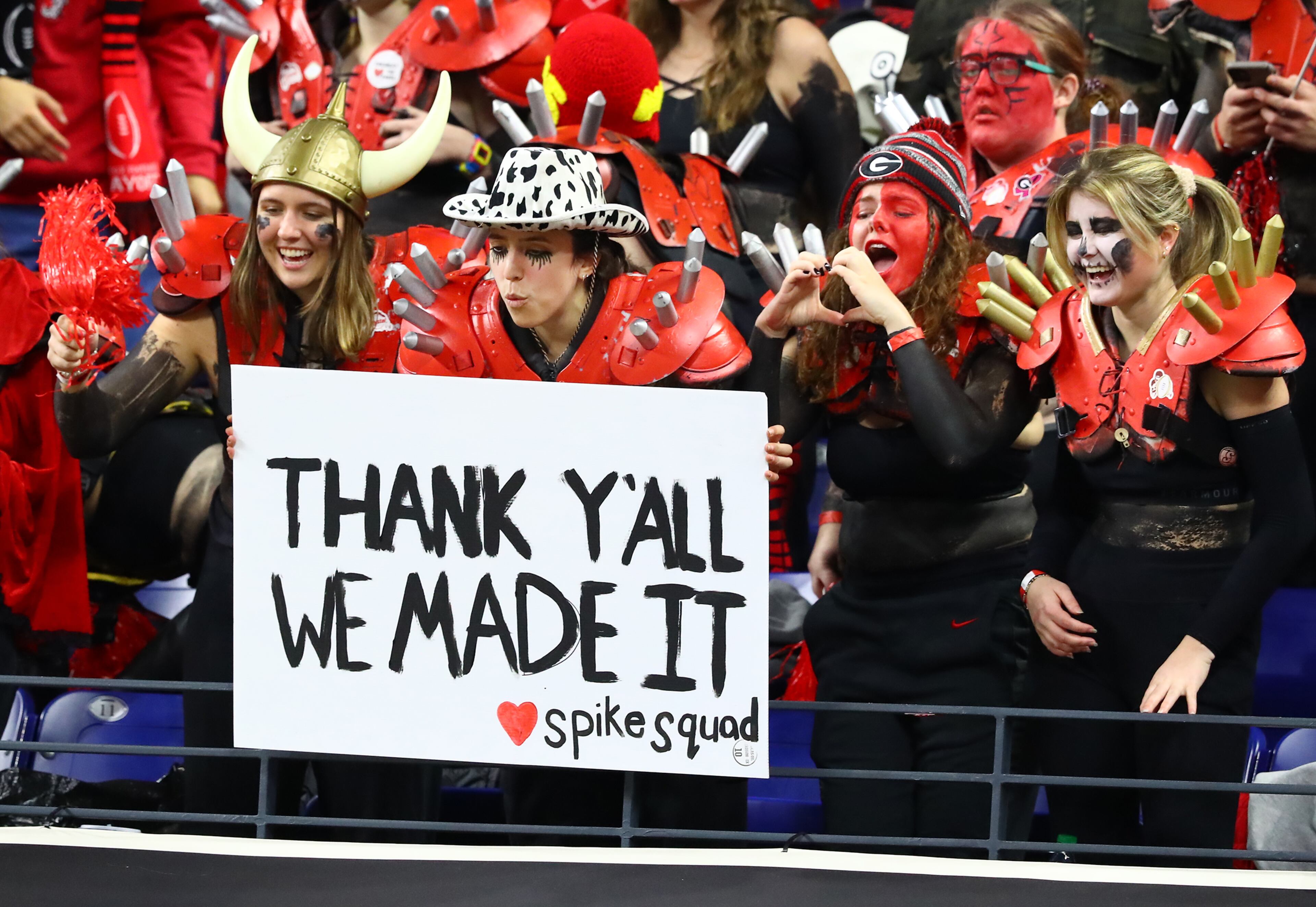 Members of the spike squad, who made it to the big game, show Georgia players some love as they take the field to prepare to play Alabama in the College Football Playoff Championship game on Monday, Jan. 10, 2022, in Indianapolis. “Curtis Compton / Curtis.Compton@ajc.com”`