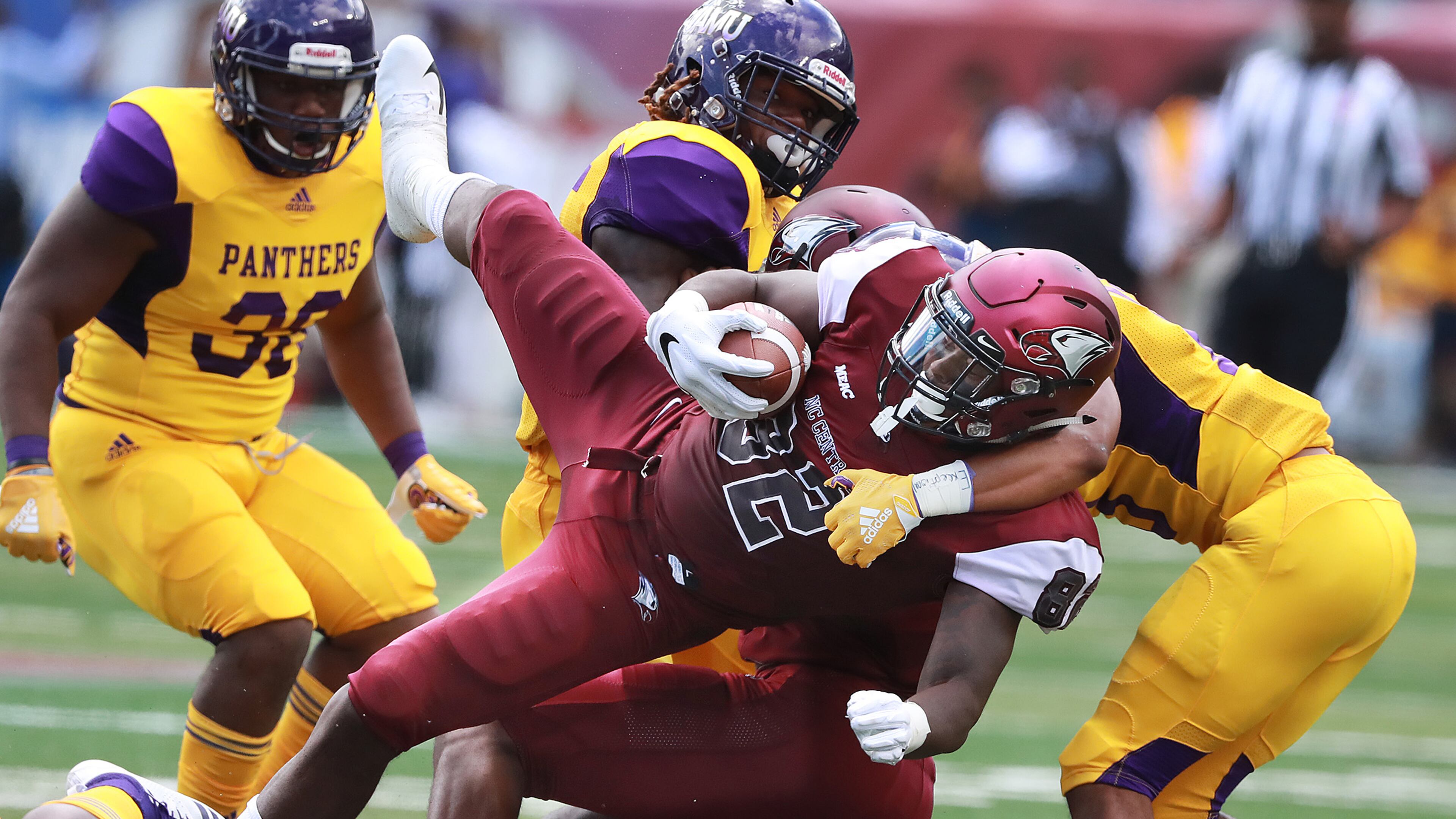 North Carolina Central tight end Josh McCoy is upended by Prairie View A&M defenders during the first quarter of the MEAC-SWAC Challenge Sunday, Sept. 2, 2018, in Atlanta.