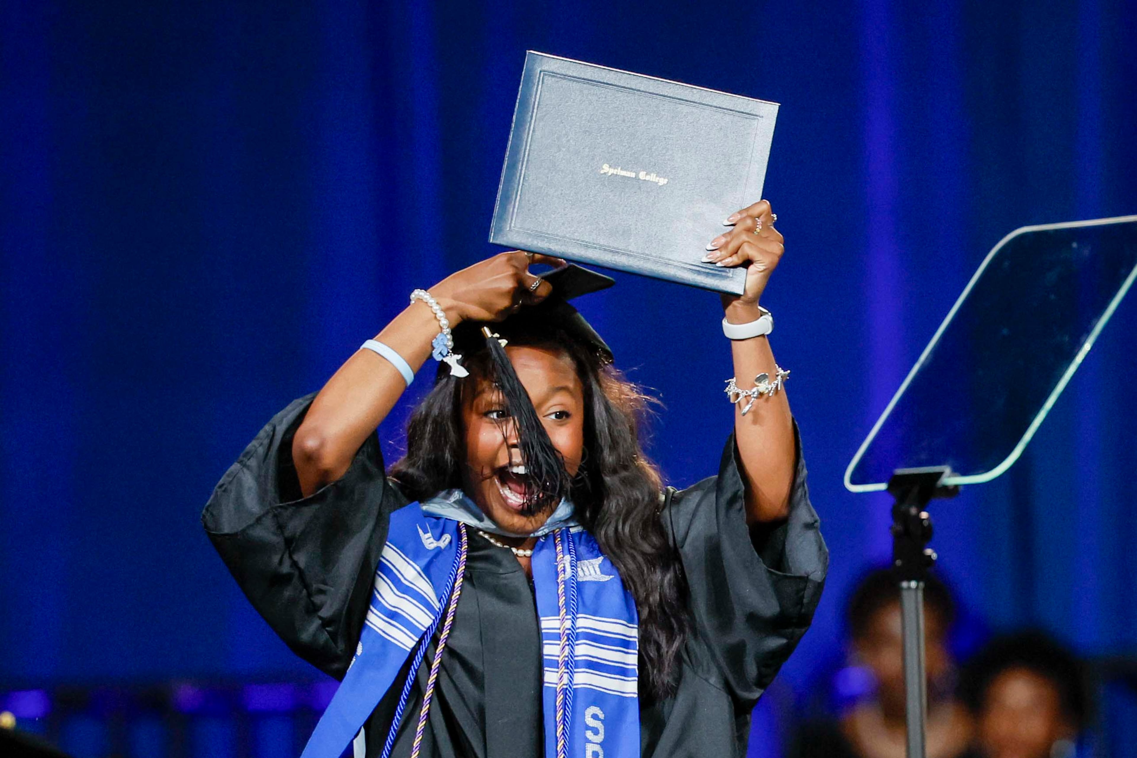 A graduate reacts after receiving her diploma during the Spelman College Commencement at the Georgia International Convention Center in College Park on Sunday, May 17, 2026. (Miguel Martinez/AJC)