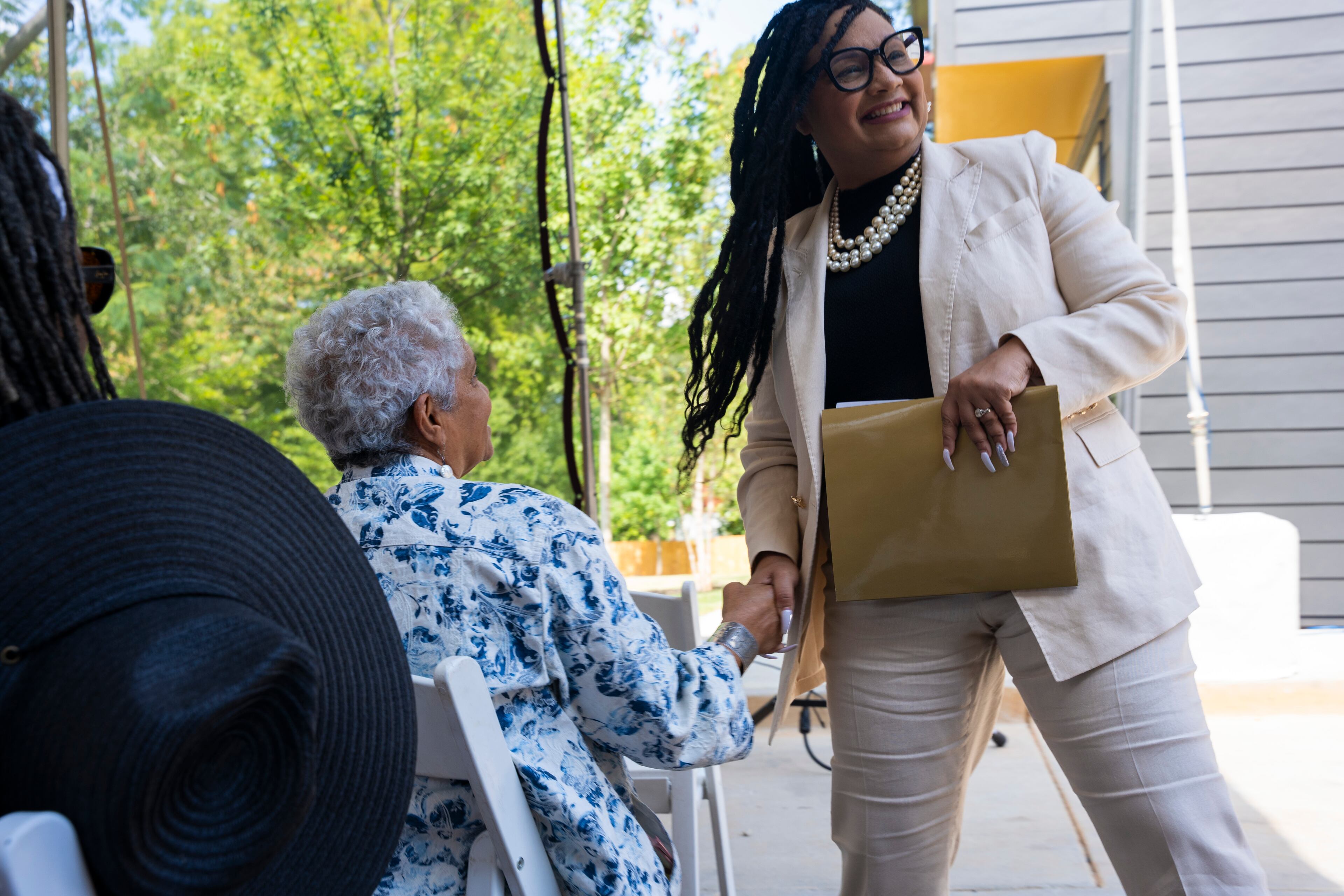 U.S. Rep. Nikema Williams (right), an Atlanta Democrat, is holding a news conference today. She is pictured shaking hands with former Atlanta Mayor Shirley Franklin.