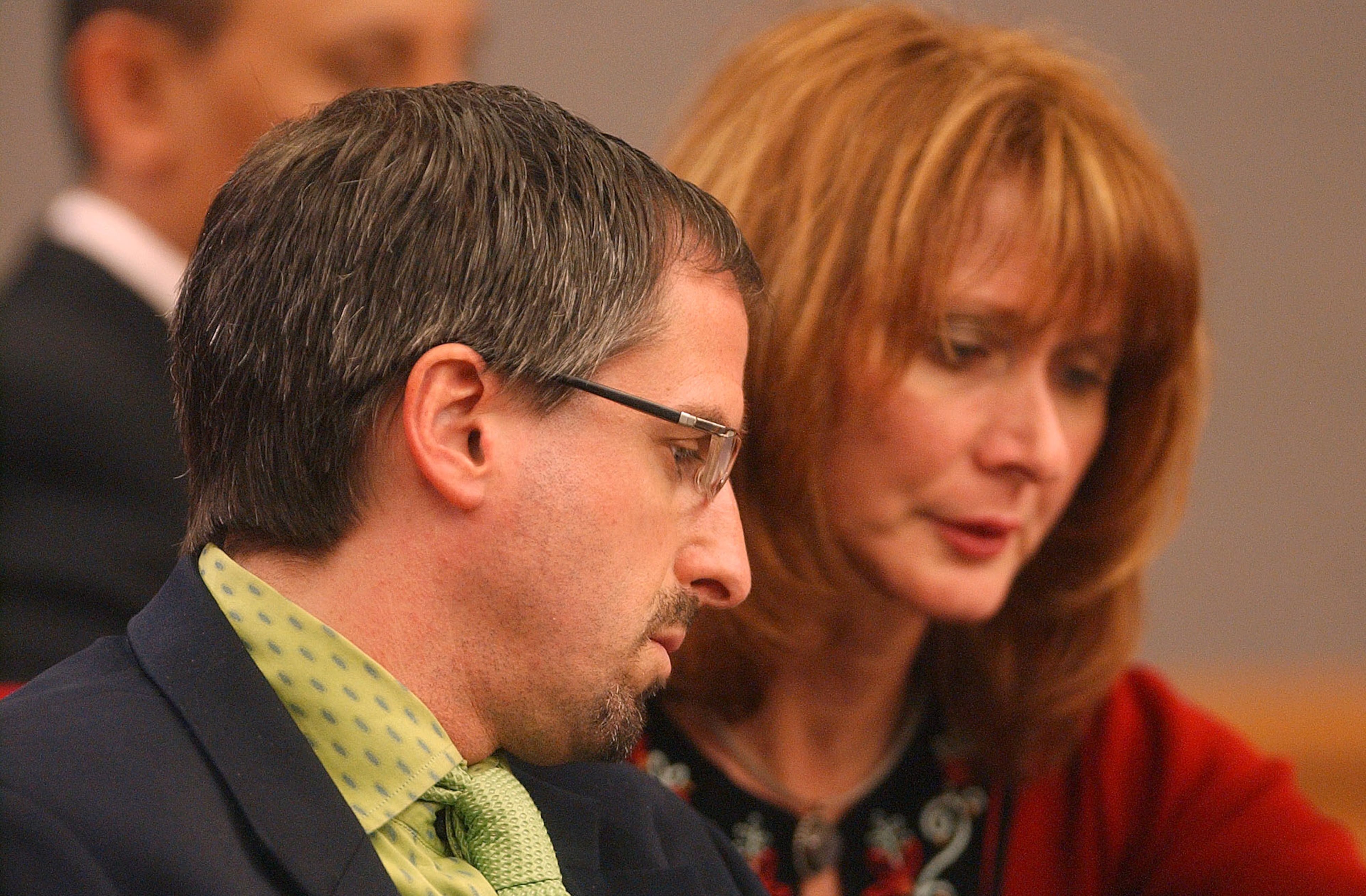 Defense attorney W. Mark Hill confers with paralegal Jeanie Costarides in court during jury selection. (VINO WONG/AJC staff)