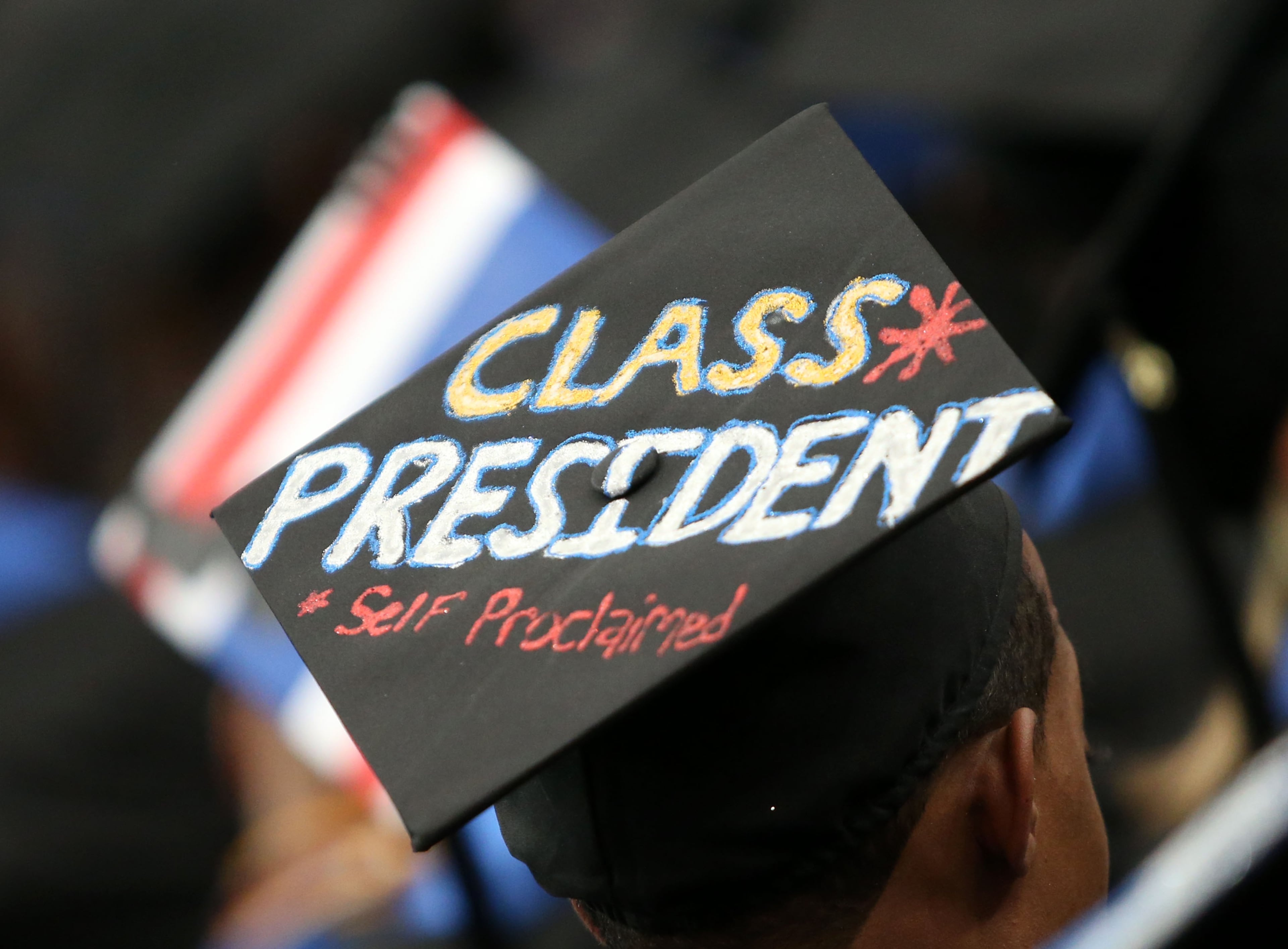 A Georgia State University graduate wears a mortarboard reading, "Class President, Self Proclaimed," during the Spring 2014 Commencement at the Georgia Dome Saturday afternoon, May 10, 2014. JASON GETZ / SPECIAL