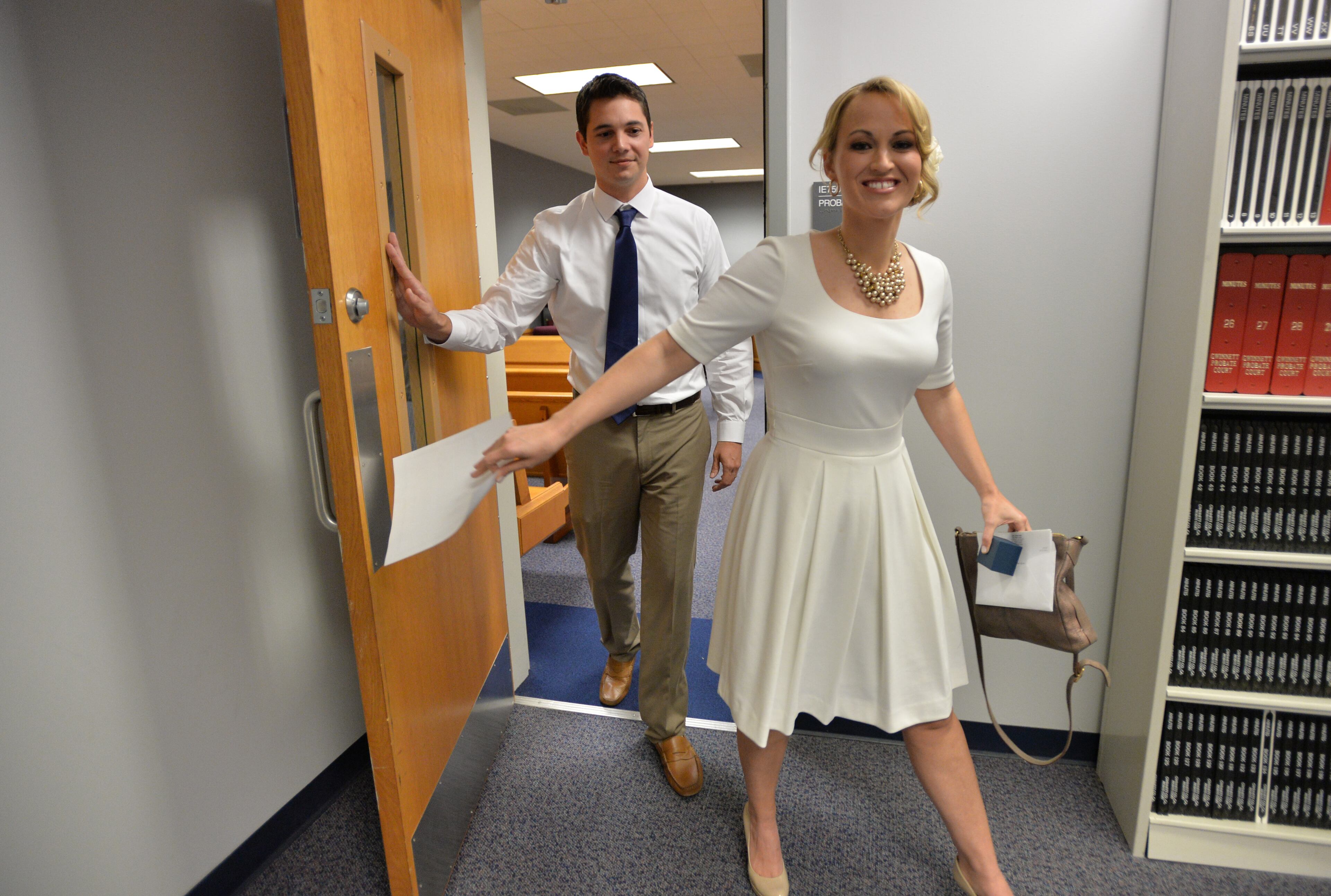 Kali Hanson holds their marriage license as she and her husband Mathew Dombrowski leave Gwinnett County Probate Court after their wedding ceremony Tuesday afternoon, November 12, 2013. The couple has been together for 5 years and they had planned to marry on the date 11/12/13.