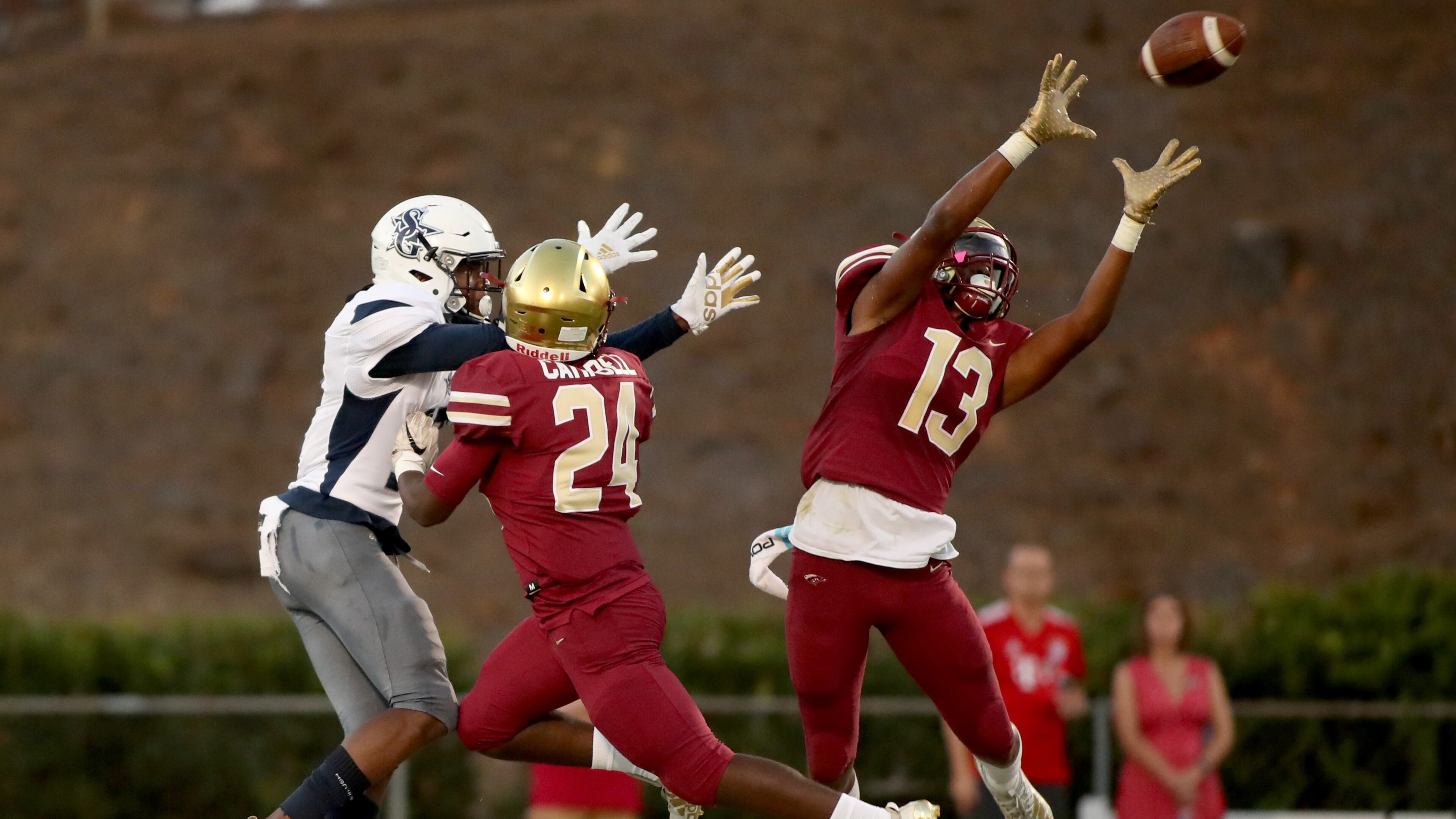 Friday Night Lights: Brookwood defensive back Jacob Burrell (13) deflects a pass intended for South Gwinnett wide receiver Armand Anderson (17) as Brookwood defensive back Patrick Cambell (24) defends in the first half of high school football action at Brookwood. (Jason Getz/Special)