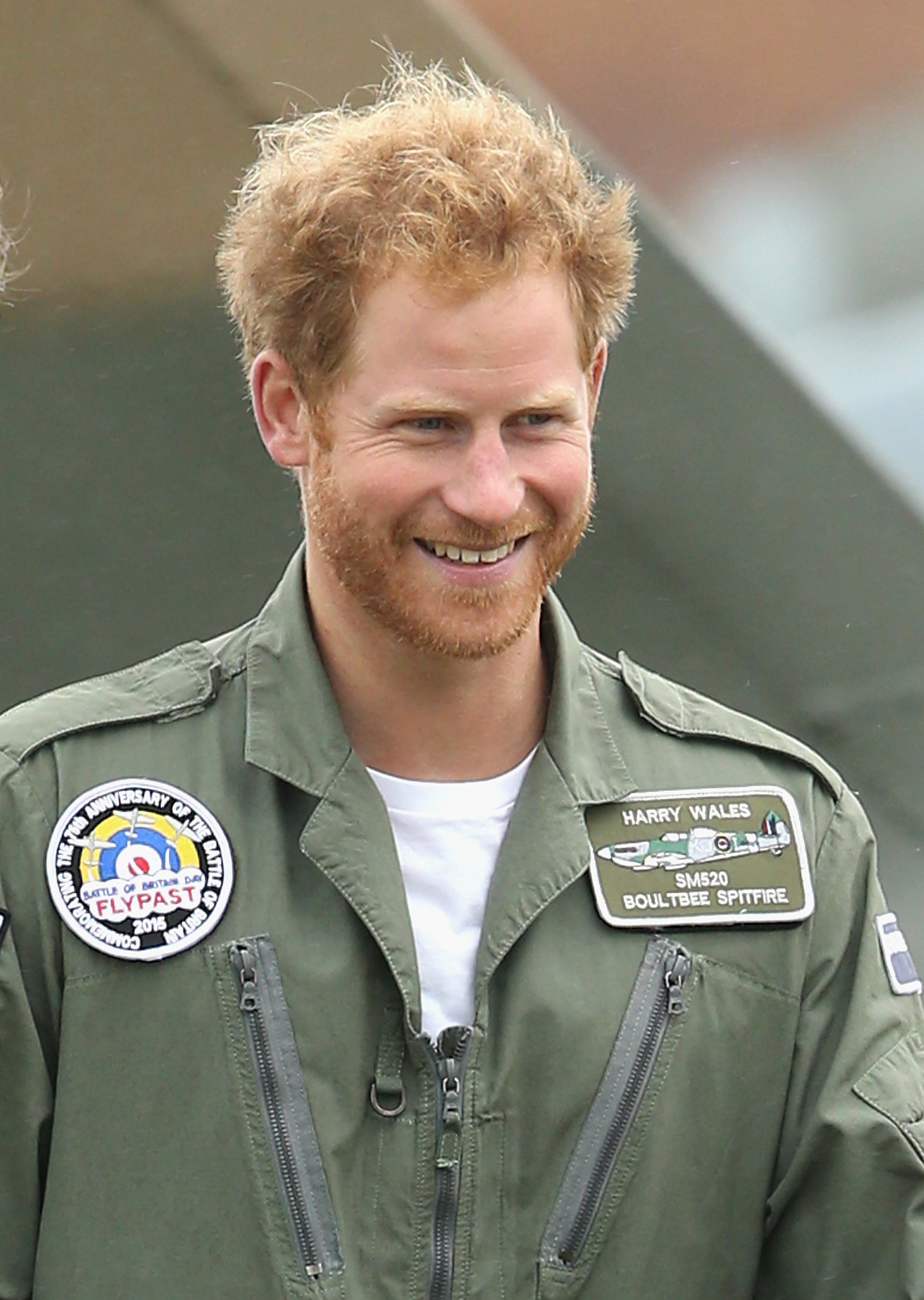 CHICHESTER, ENGLAND - SEPTEMBER 15: Prince Harry walks on the airfield at Goodwood Aerodrome as he is shown a Spitfire Aircraft that will take place in a Battle of Britain Flypast at Goodwood on September 15, 2015 in Chichester, England. The 75th Anniversary of the Battle of Britain is being marked by a historic flypast that brings more Battle of Britain aircraft together than ever before as a show of thanks to 'the few' and the sacrifices they made. (Photo by Chris Jackson/Getty Images)