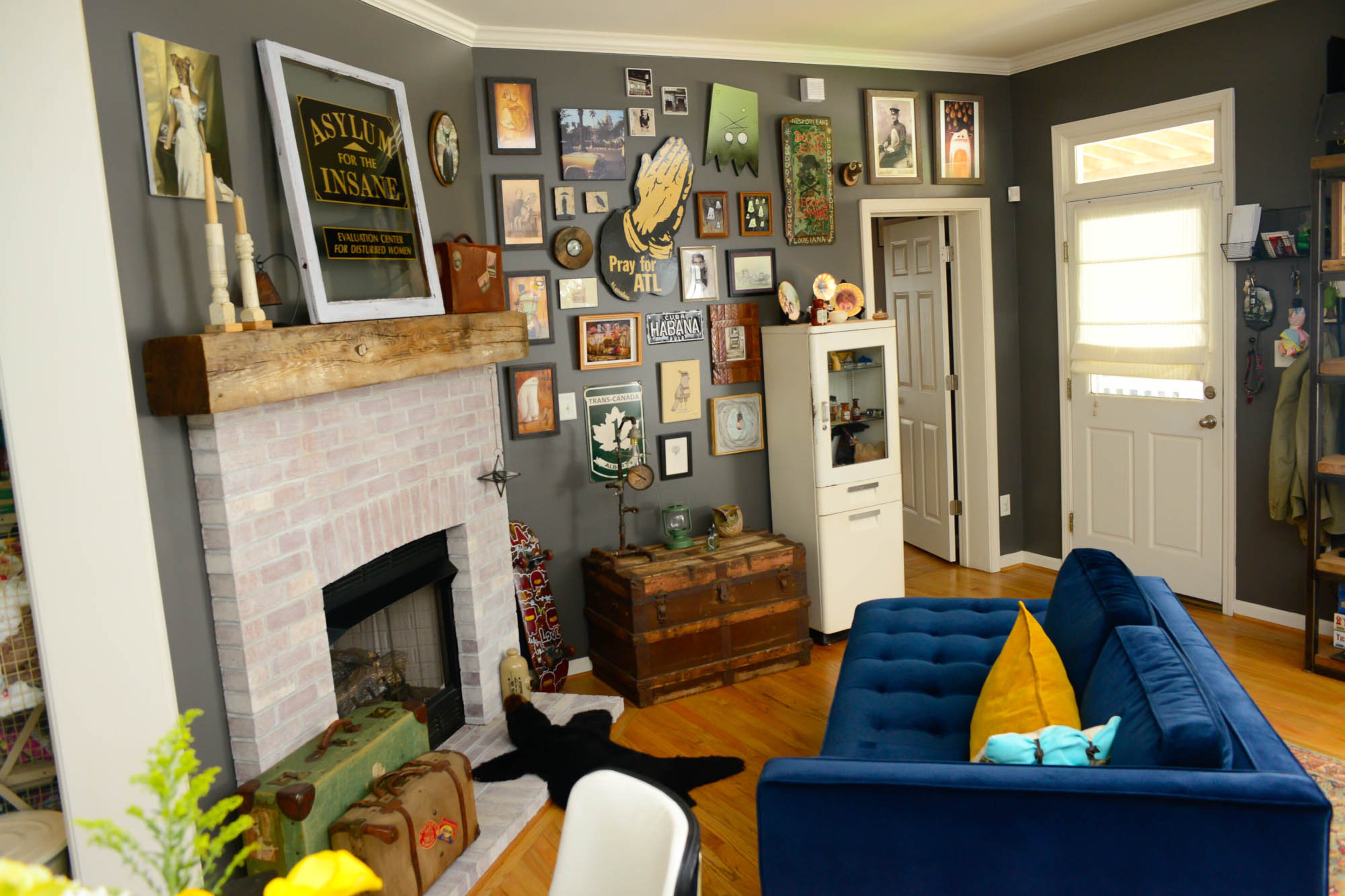 The art gives the home character and personality. A chaise lounger from Room and Board and a whitewashed fireplace strike a balance between quirk and style.