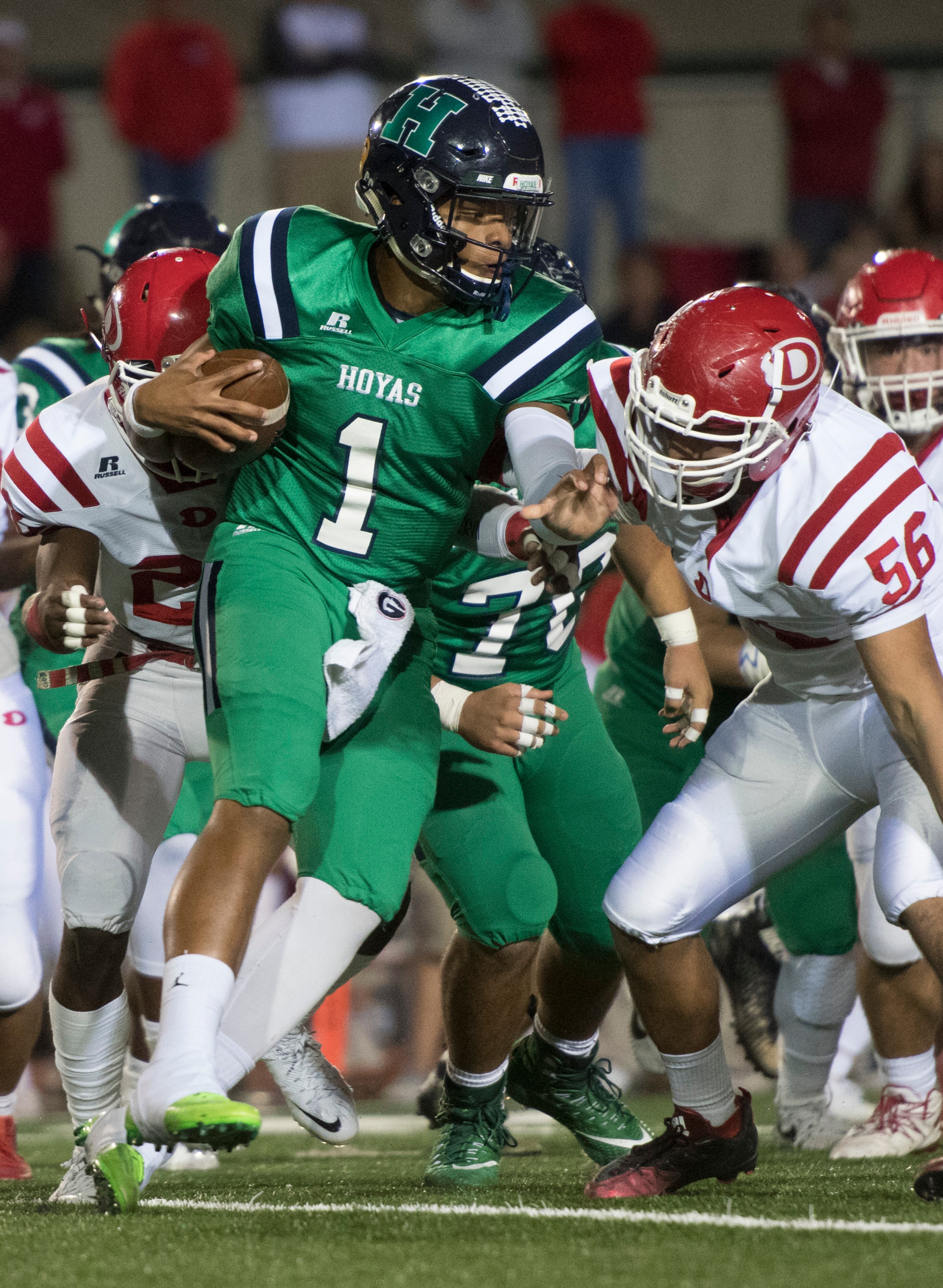 Harrison quarterback Justin Fields (1) runs against the defense of Dalton defensive end Kevin Diaz (56) during a high school football game on Thursday, Oct. 19, 2017, in Kennesaw, Ga. (Special to the Atlanta Journal-Constitution, John Amis )