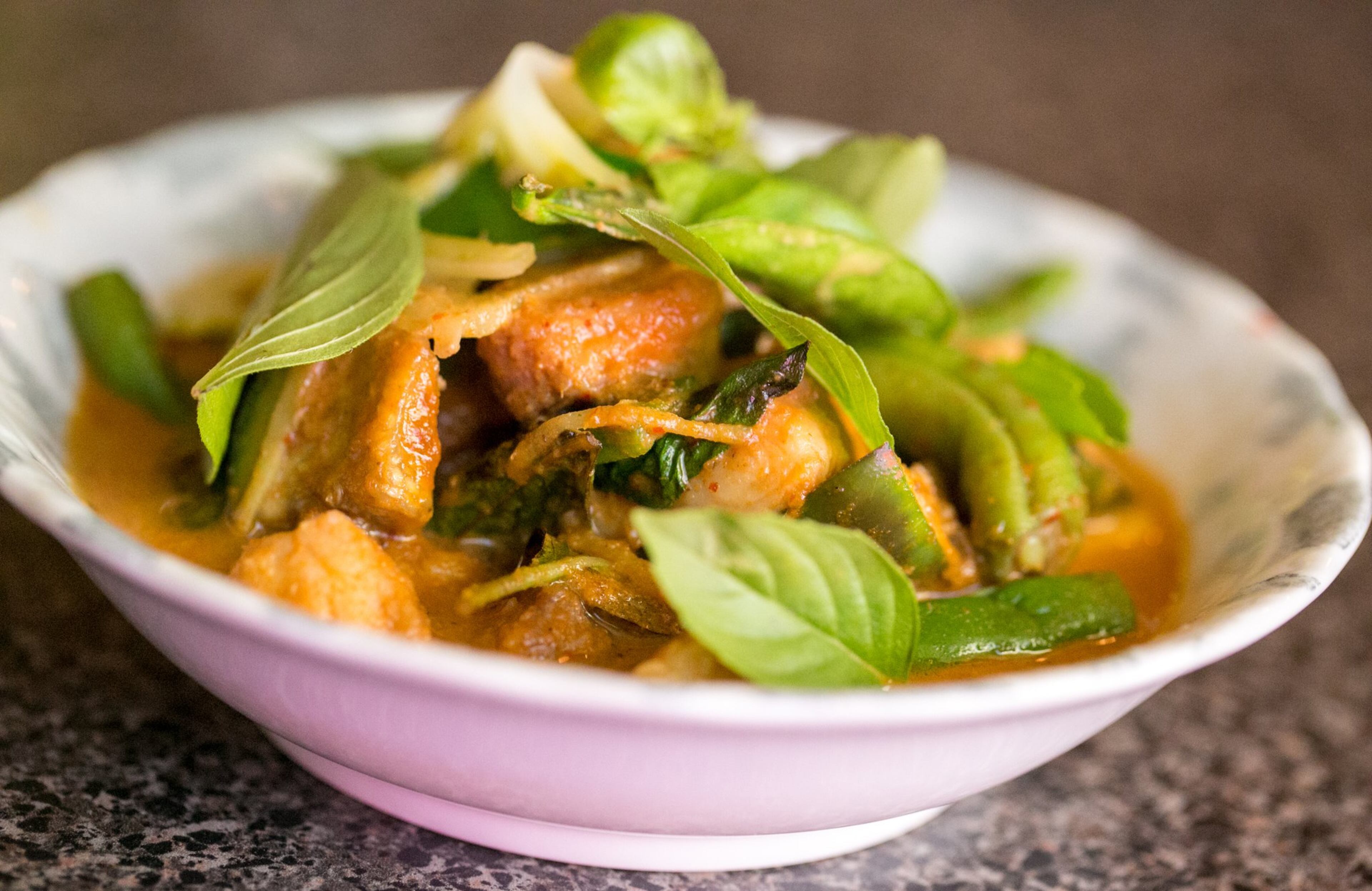 At the 30-seat Gato space in Candler Park, former Kimball House chefs Parnass Lim Savang and Rod Lassiter present Talat Market, a pop-up with a menu of up to eight creative Thai dishes made with Georgia-grown ingredients. Talat Market will open a permanent location in Summerhill in 2019. Talat Market serves a Thai red curry catfish with eggplant, rattlesnake beans, lime basil, ginger and pickled green tomatoes. JENNI GIRTMAN / ATLANTA EVENT PHOTOGRAPHY