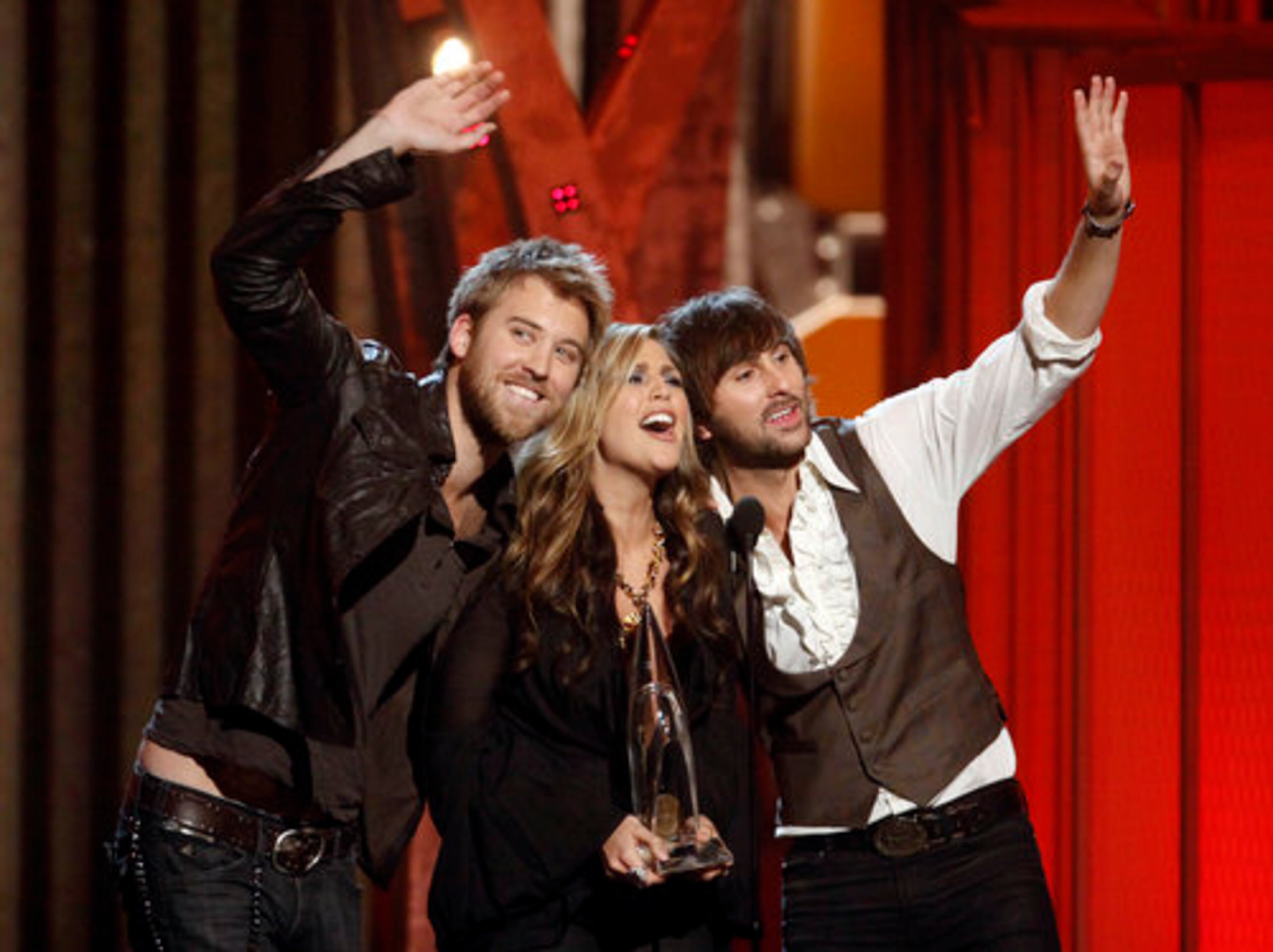 Charles Kelley (from left), Hillary Scott and Dave Haywood of the band Lady Antebellum accept the New Artist of the Year award.