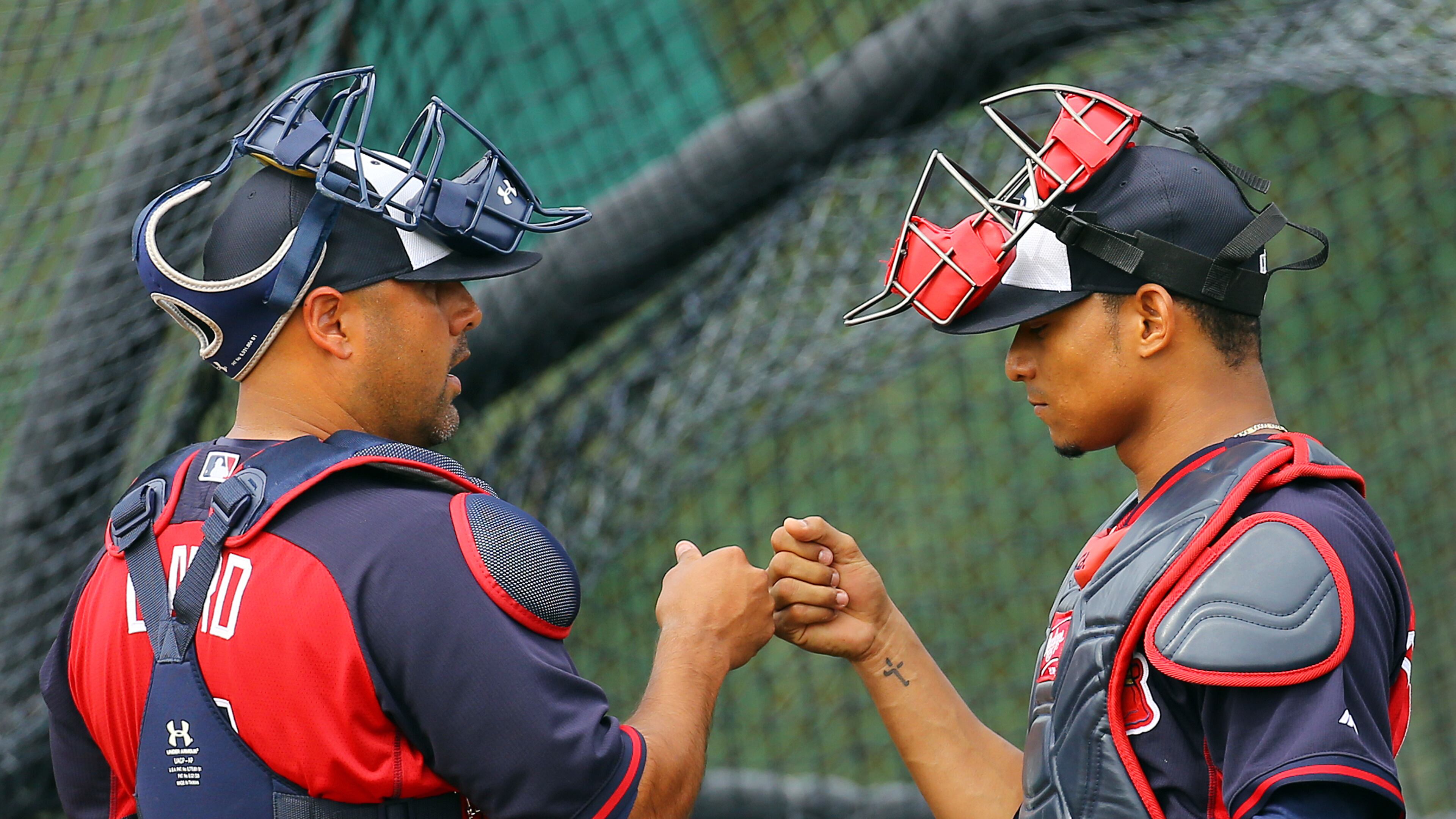 022114 LAKE BUENTA VISTA: Braves catchers Gerald Laird and Christian Bethancourt bump knuckles at the conclusion of catching drills during spring training on Friday, Feb. 21, 2014, in Lake Buena Vista, FL. CURTIS COMPTON / CCOMPTON@AJC.COM If Gerald Laird (left) and Christian Bethancourt are Braves' top catchers, Evan Gattis would move to outfield. (Curtis Compton)