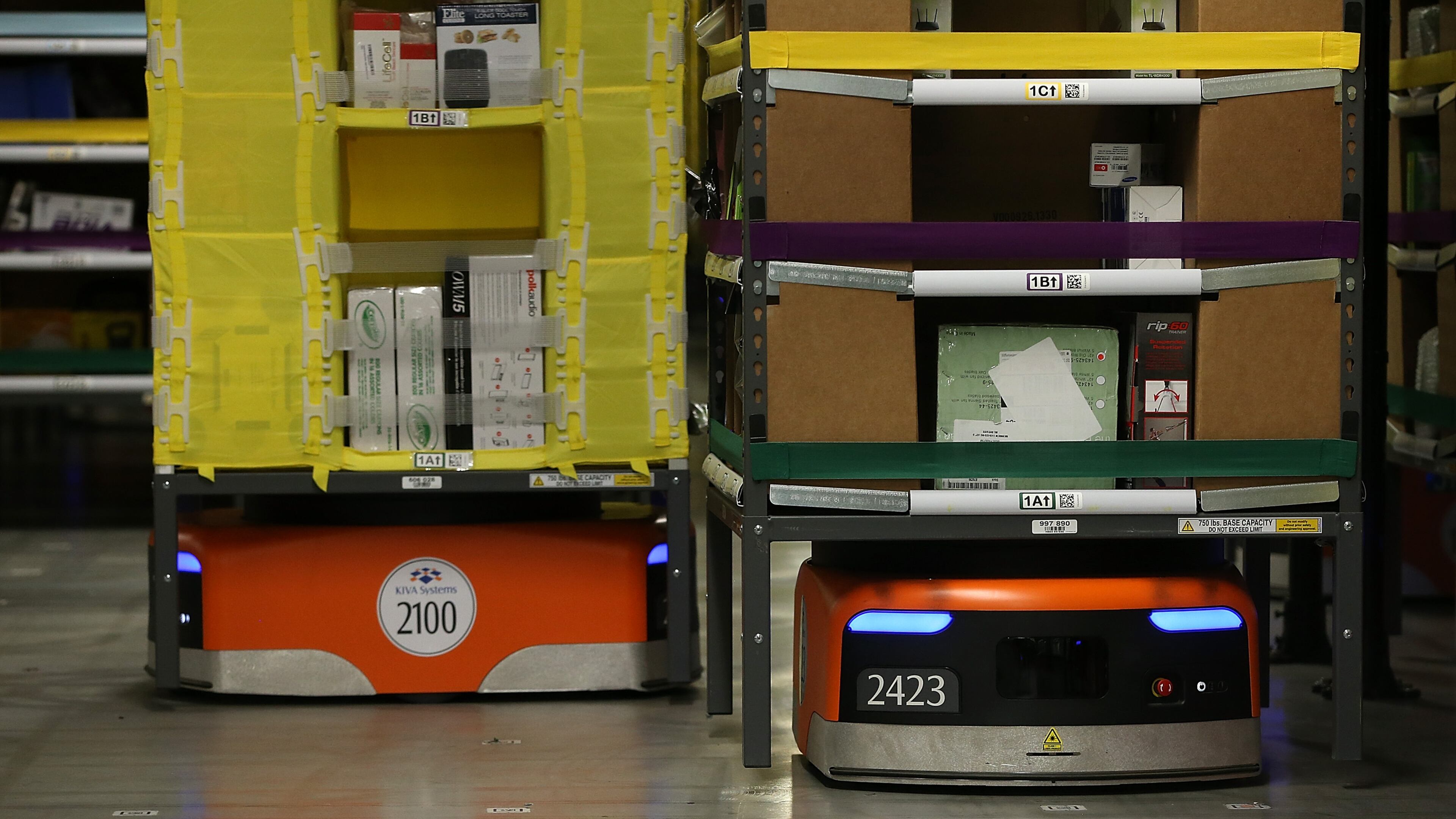 TRACY, CA - JANUARY 20: Kiva robots move racks of merchandise at an Amazon fulfillment center on January 20, 2015 in Tracy, California. Amazon officially opened its new 1.2 million square foot fulfillment center in Tracy, California that employs more than 1,500 full time workers as well as 3,000 Kiva robots that can fetch merchandise for workers and are capable of lifting up to 750 pounds. Amazon is currently using 15,000 of the robots spread over 10 fulfillment centers across the country. (Photo by Justin Sullivan/Getty Images)