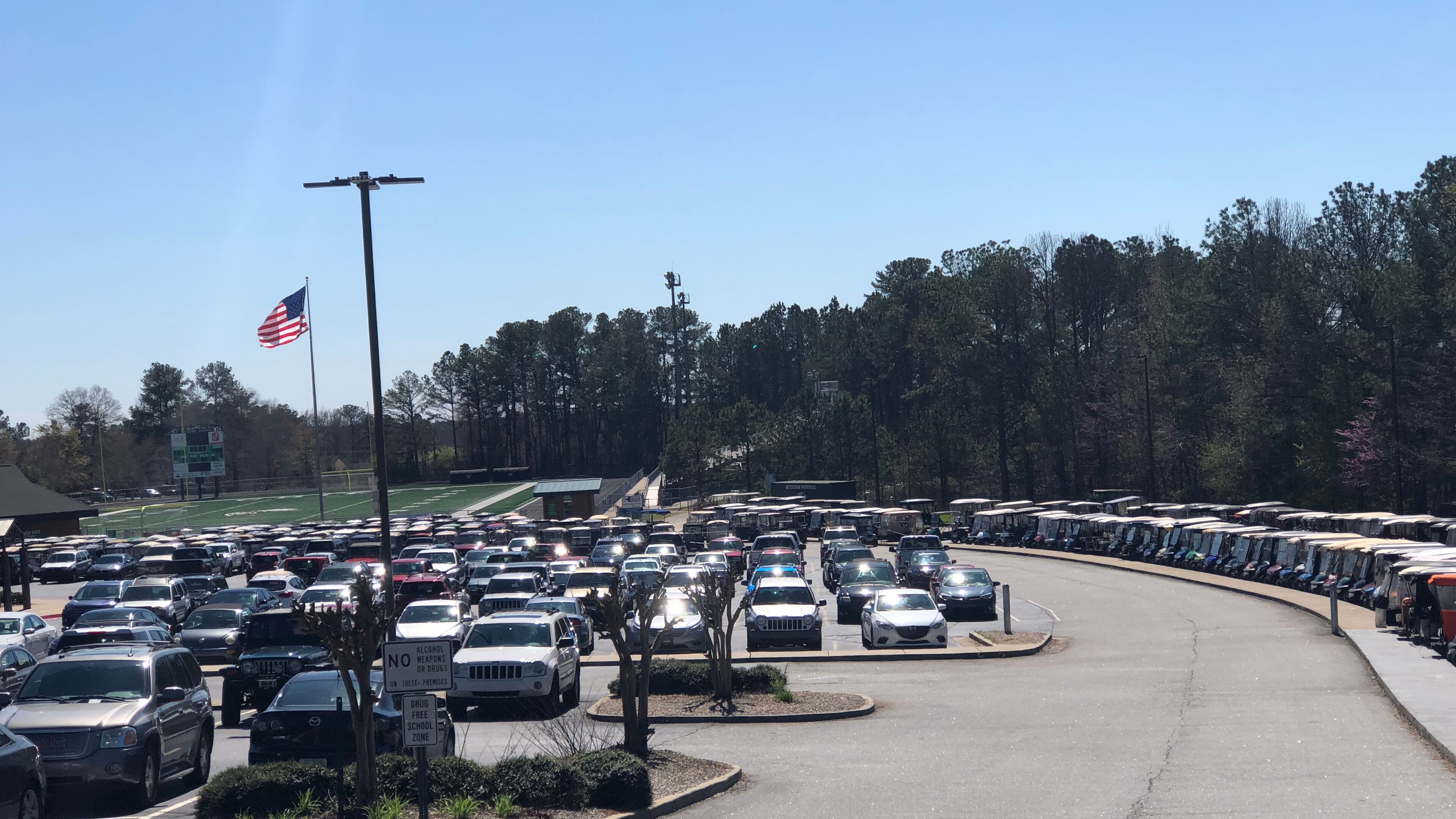 Rows of golf carts sit near a parking lot at McIntosh High School in Peachtree City. LEON STAFFORD/AJC