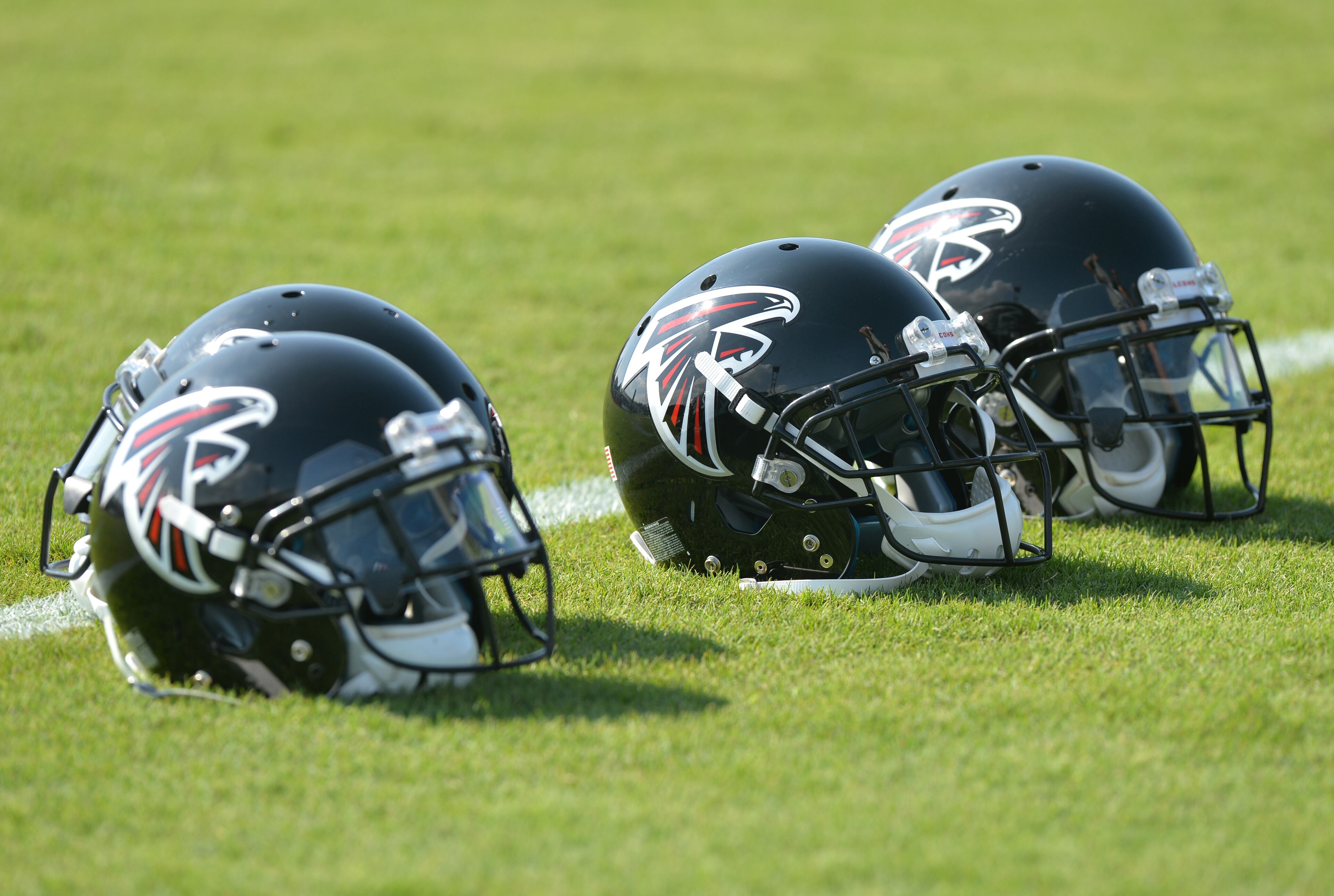 Atlanta Falcons helmets glisten in the sun during training camp on Friday, July 25, 2014, in Flowery Branch.