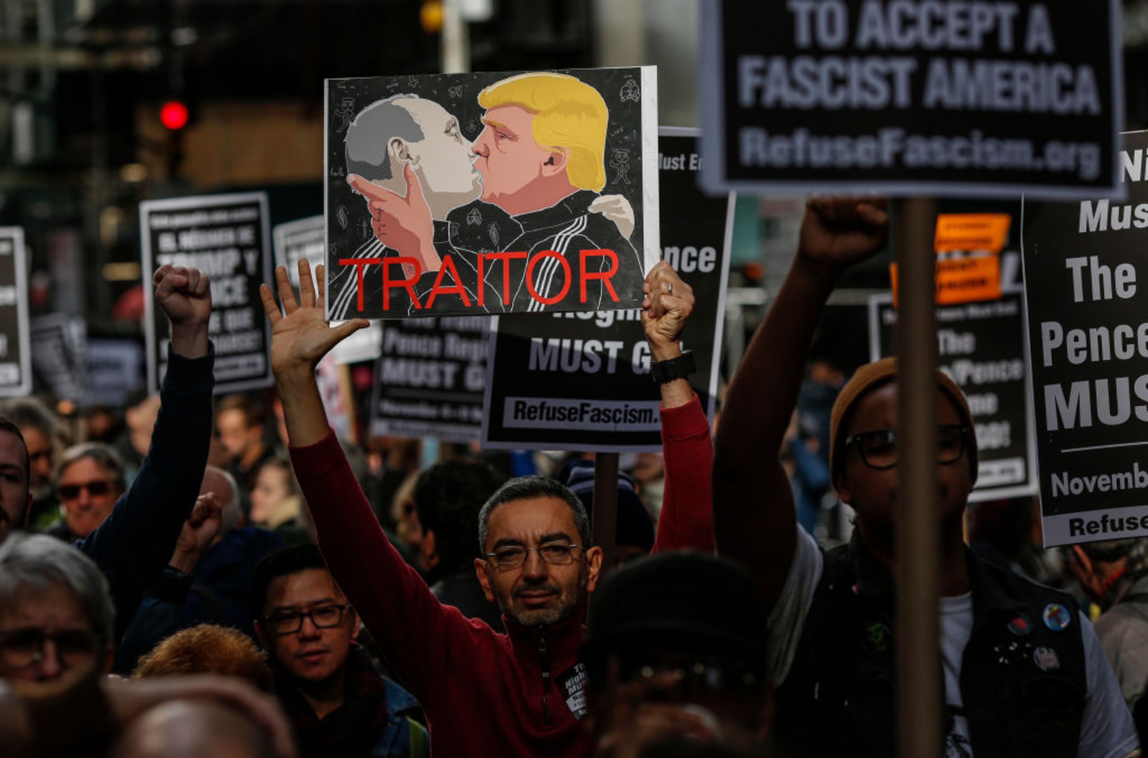 NEW YORK, NY - NOVEMBER 04: A man holds a placard as he takes part in a nationwide protest against the Trump administration in Times Square on November 4, 2017 in New York City. Anti-Trump protests are scheduled for major cities across the country today including New York, Chicago and Los Angeles. (Photo by Kena Betancur/Getty Images)