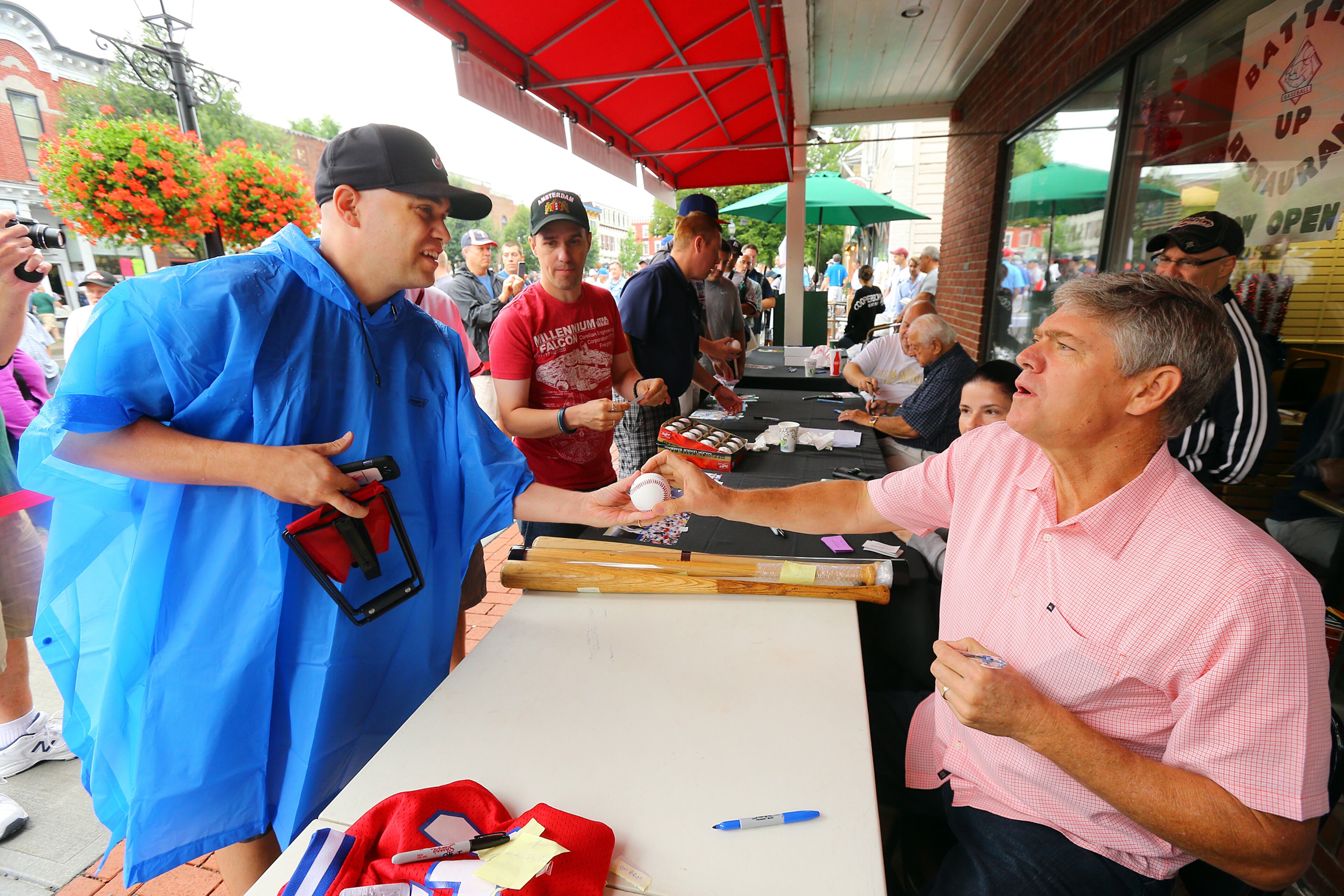 Former Braves player Dale Murphy signs an autograph for Philip Jones, Douglasville, GA, on Main Street on Sunday, July 27, 2014, in Cooperstown.