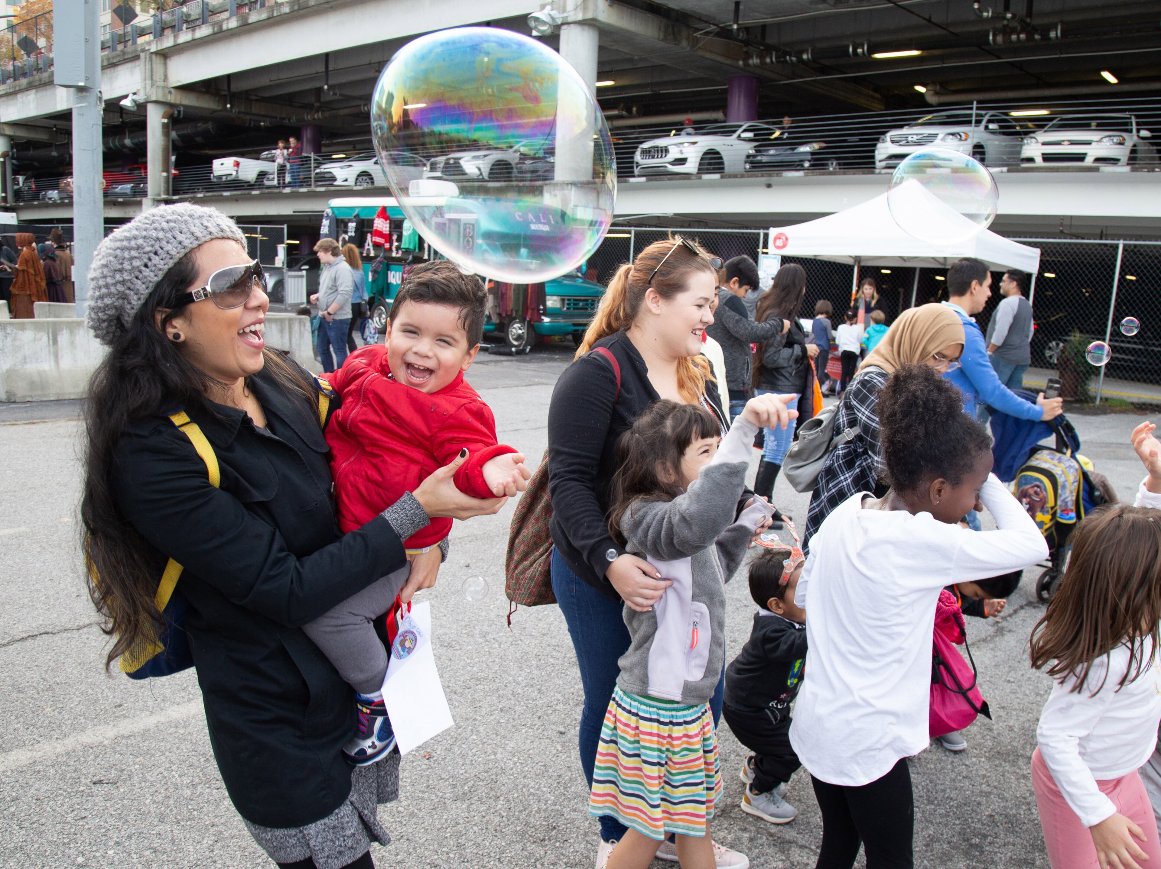 Adelayde Rivas and her son Liam Blem, 2, pop giant bubbles during the Light the Station 2018 holiday event Saturday, November 17, 2018, at Atlantic Station in Atlanta. (Photo: STEVE SCHAEFER / SPECIAL TO THE AJC)