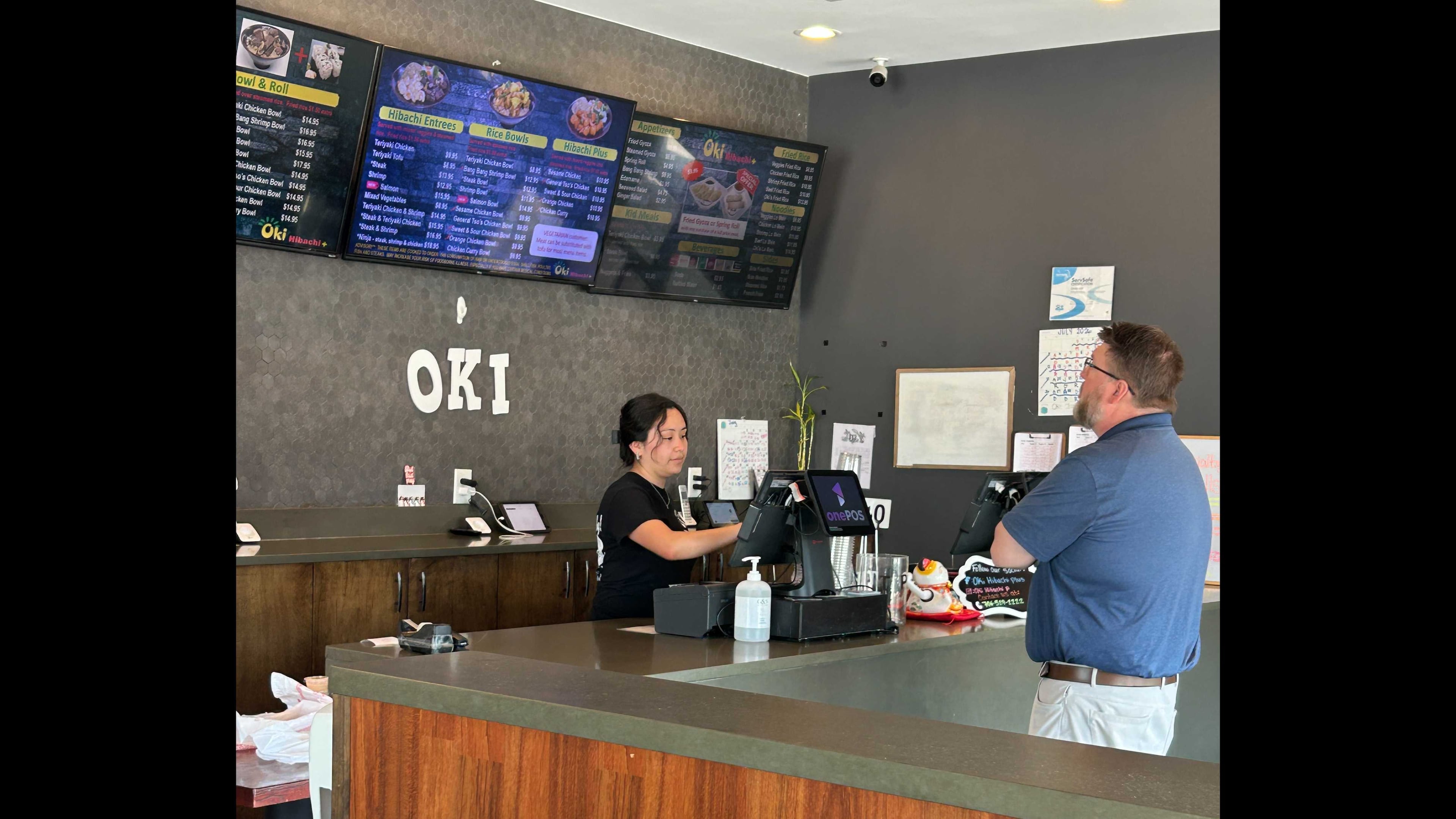 Karen Ajanel serves a customer at her job. Ajanel, a Dalton State College student, credits the Orange Duffel Bag Initiative, credits the program with helping in her academic journey. (Courtesy)