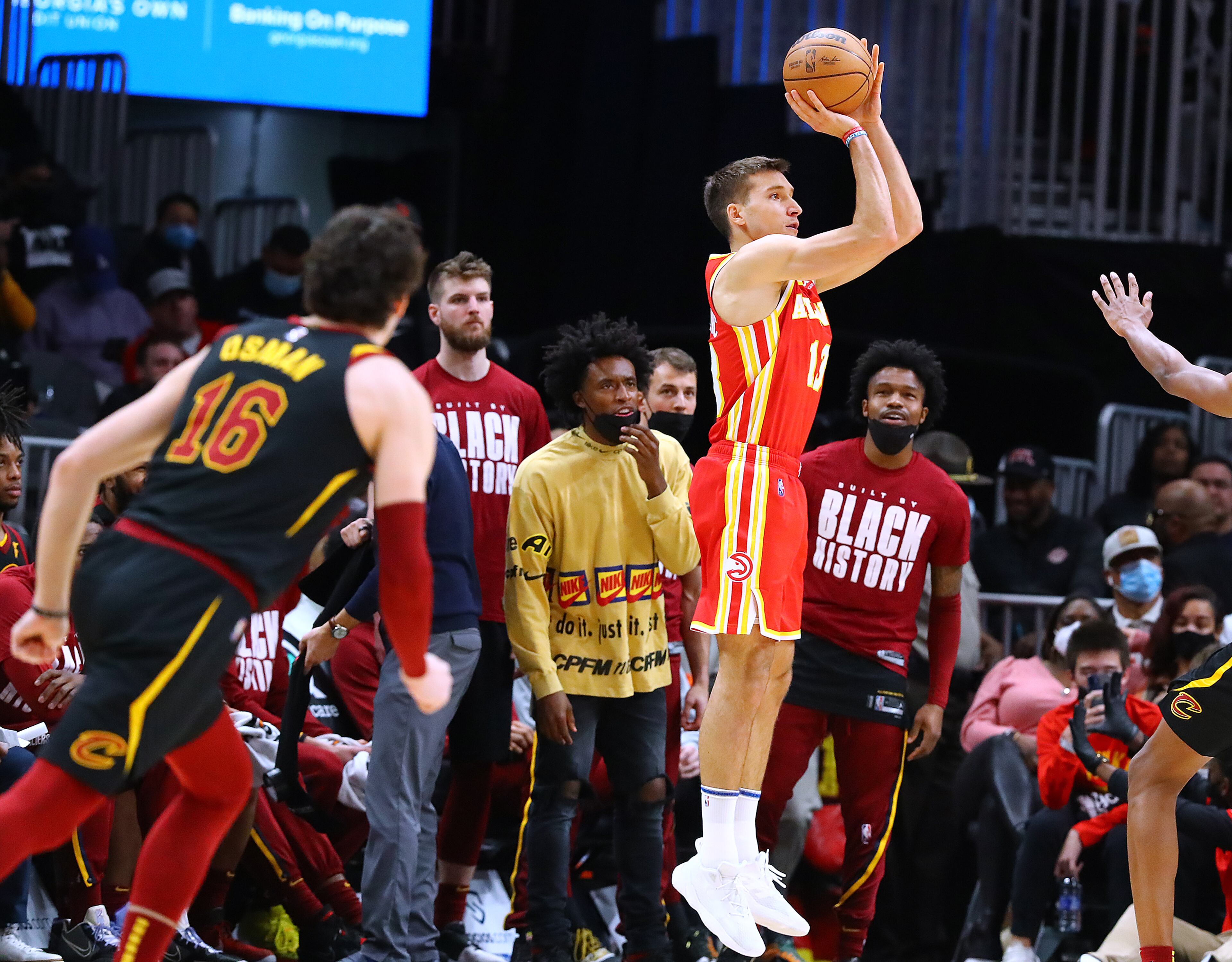 Hawks guard Bogdan Bogdanovic hits a three against the Cleveland Cavaliers during the final minutes of a 124-116 victory in a NBA basketball game on Tuesday, Feb. 15, 2022, in Atlanta. “Curtis Compton / Curtis.Compton@ajc.com”`
