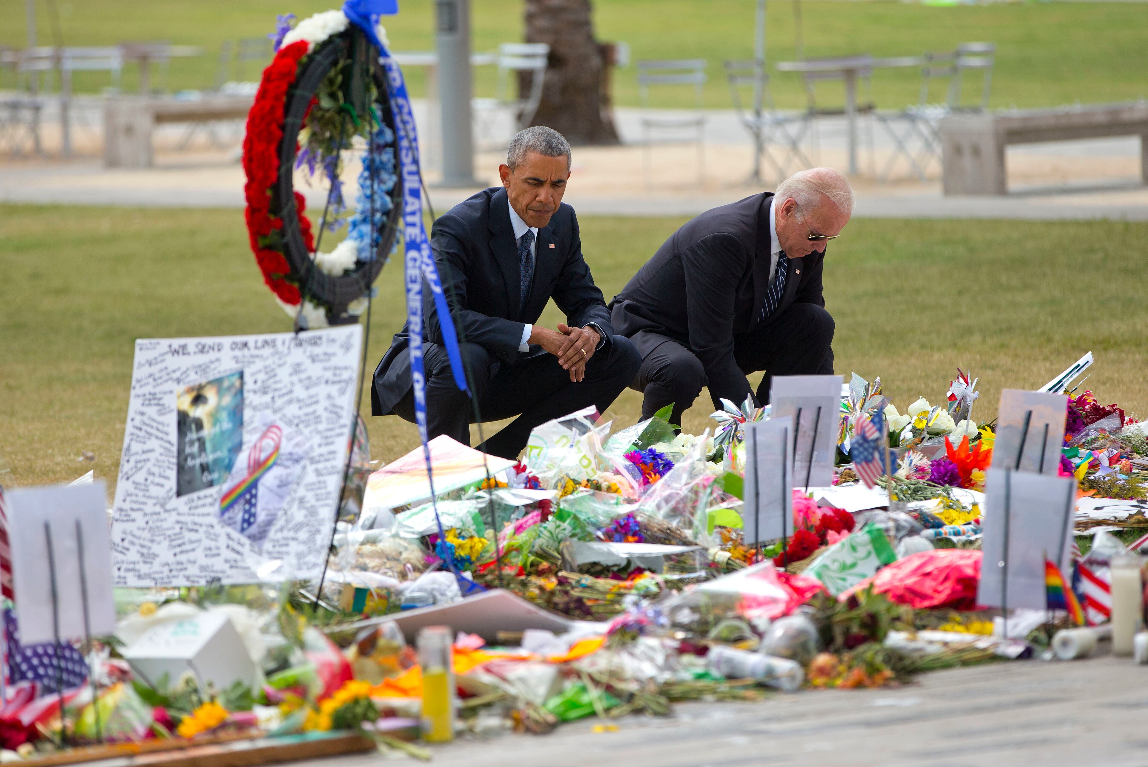 President Barack Obama and Vice President Joe Biden visit a memorial to the victims of the Pulse nightclub shooting, Thursday, June 16, 2016 in Orlando, Fla. Offering sympathy but no easy answers, Obama came to Orlando to try to console those mourning the deadliest shooting in modern U.S history. (AP Photo/Pablo Martinez Monsivais)