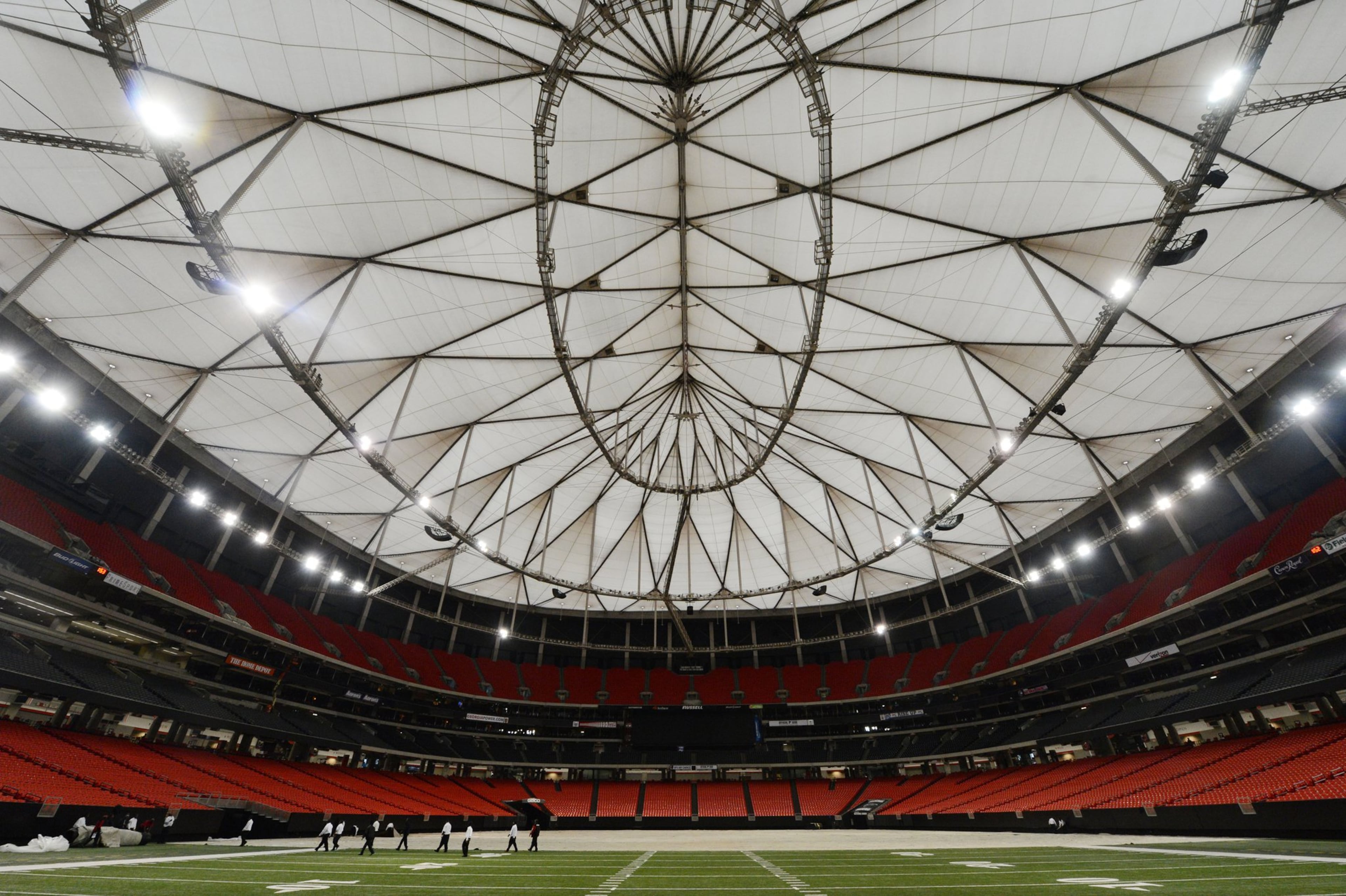 FEBRUARY 7, 2013 ATLANTA Work crews cover the playing field with a tarp in preparation for next week’s Monster Truck event at the Georgia Dome Friday, February 8, 2013. Mayor Kasim Reed’s argument that Atlanta needs a new stadium is being augmented by a new charge: the Georgia Dome is in need of hundreds of millions in renovations, including a new roof. The mayor’s comments are a new wrinkle in attempts to persuade residents and other politicians to spend public dollars to help build a new stadium. Up to now, the discussion has focused on making the Dome’s biggest client, the Atlanta Falcons, happy - a losing strategy in the court of public opinion. But the mayor’s “dumpy Dome” argument may also be a tough sell. The facility is largely seen as well maintained by the public and tenants and may not be enough to convince residents that the public should help build the Falcons a new home. Story will include comments from Dome goers and outline updates Dome operators say the facility needs as well as money already put into updating the 20-year-old stadium, including the $20.5 million paint job it got in 2007. KENT D. JOHNSON / KDJOHNSON@AJC.COM