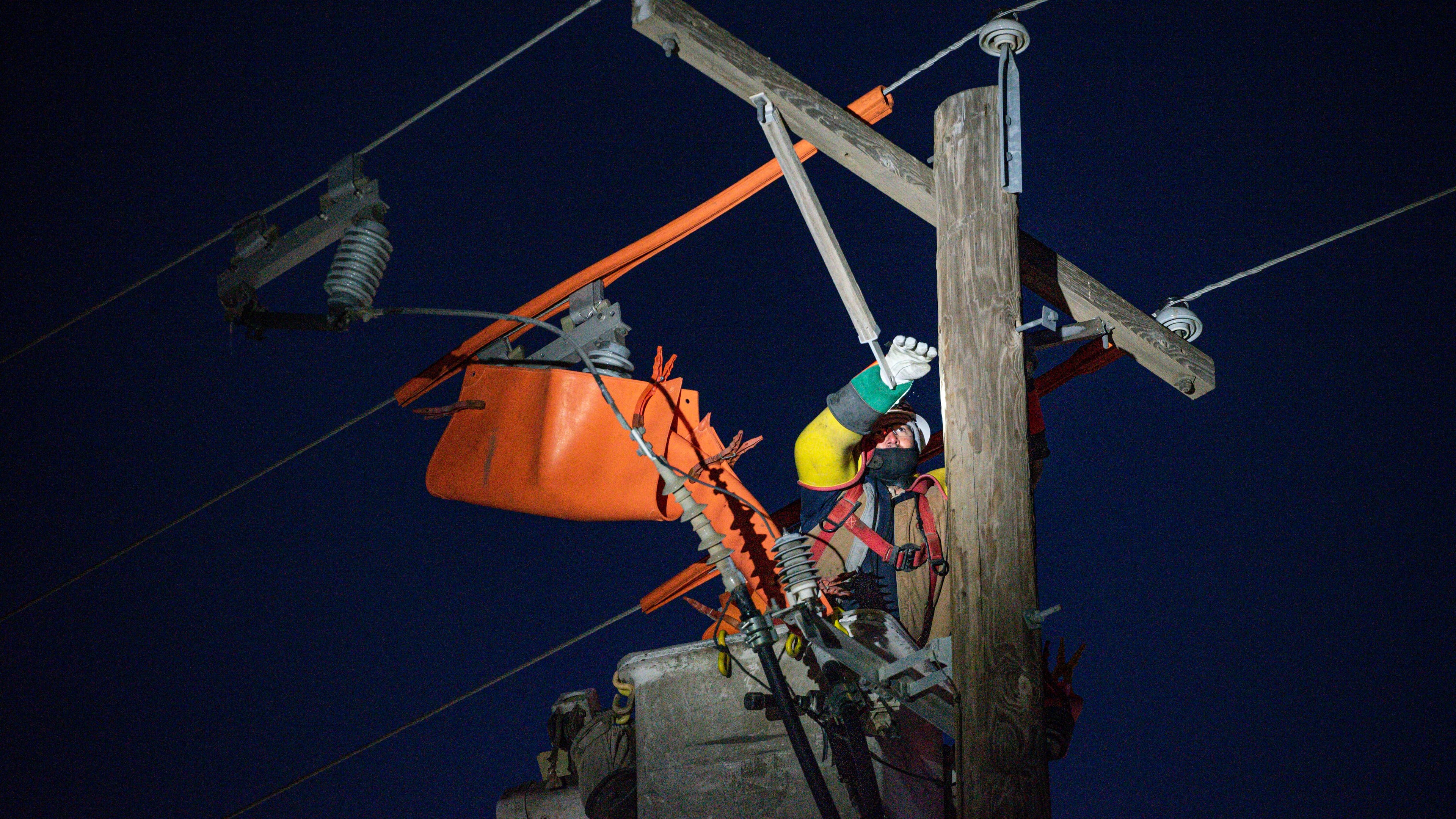 FILE - Oncor apprentice lineman Brendan Waldon repairs a utility pole that was damaged by a winter storm on Feb. 18, 2021, in Odessa, Texas. (Eli Hartman/Odessa American via AP, File)