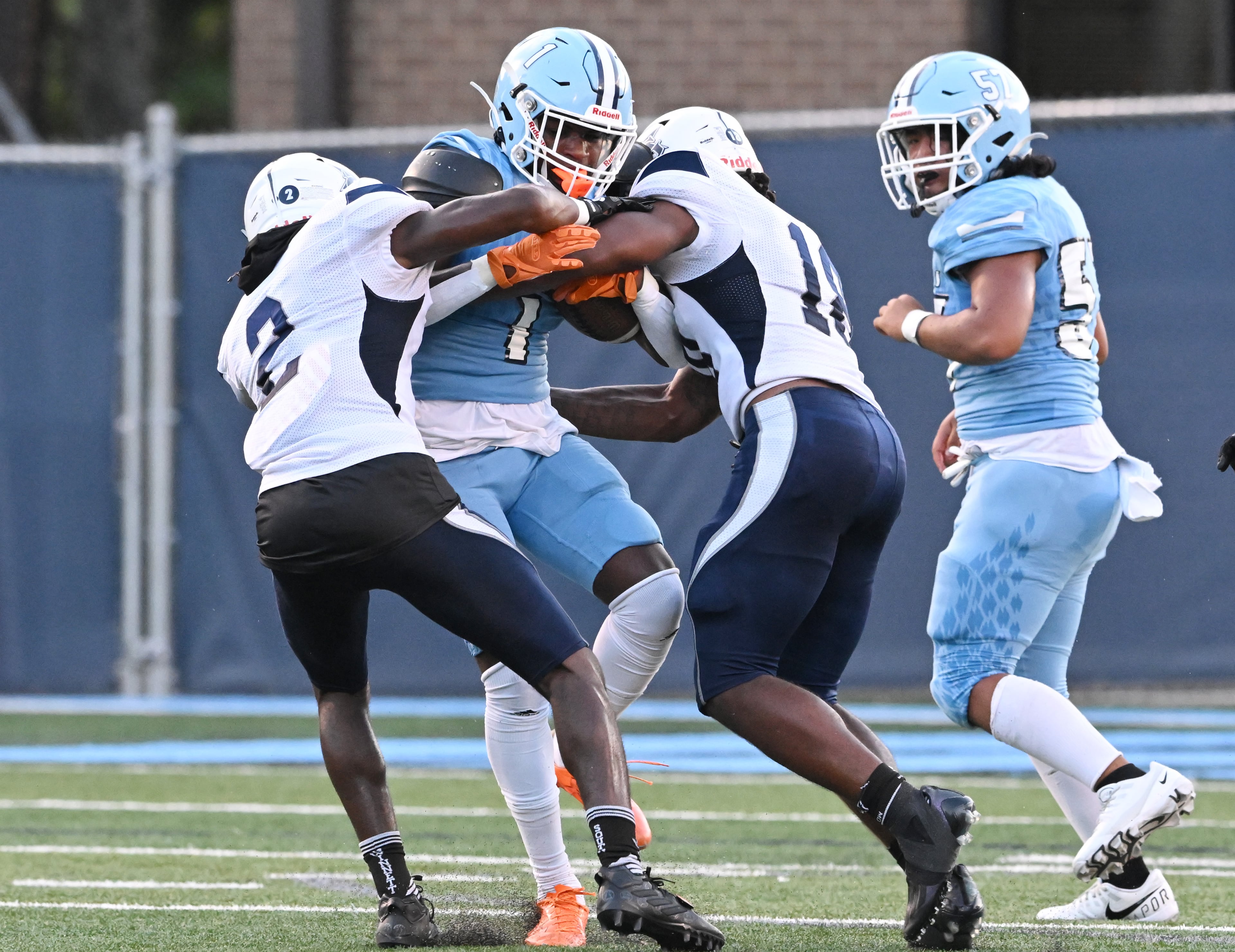 August 26 , 2022 Norcross - Meadowcreek's Andre Craig (1) gets tackled from South Gwinnett's Darius Owens (2) and South Gwinnett's Jay Miller (18) during the first half at Meadowcreek High School in Norcross on Friday, August 26, 2022. (Hyosub Shin / Hyosub.Shin@ajc.com)
