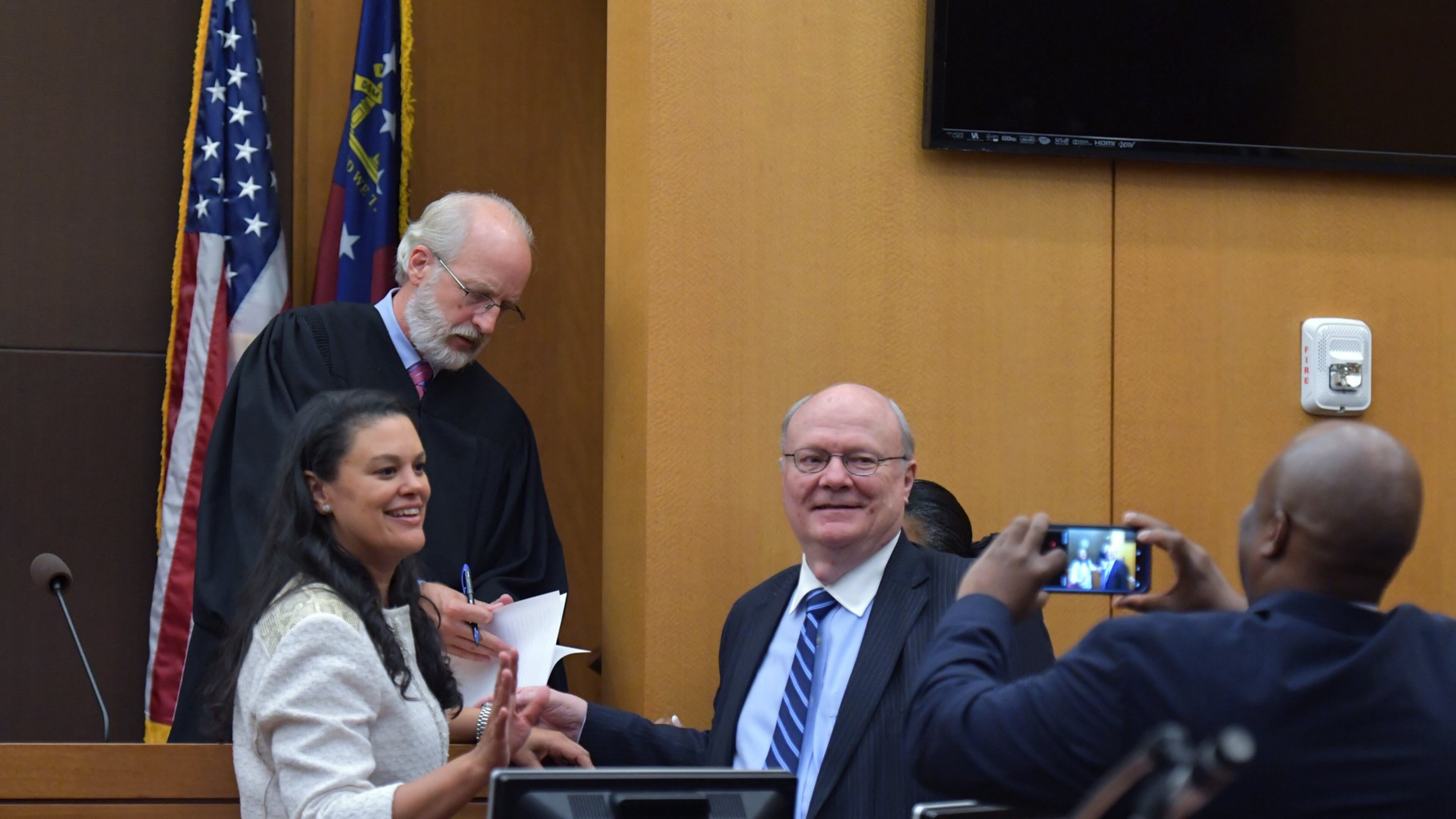 August 14, 2018 Atlanta - Meria Carstarphen, superintendent of Atlanta Public Schools (left), and attorney Charles Huddleston pose in front of Judge Alan Harvey (background) after ruling to allow Fulton County to collect tax money on Tuesday, August 14, 2018. HYOSUB SHIN / HSHIN@AJC.COM