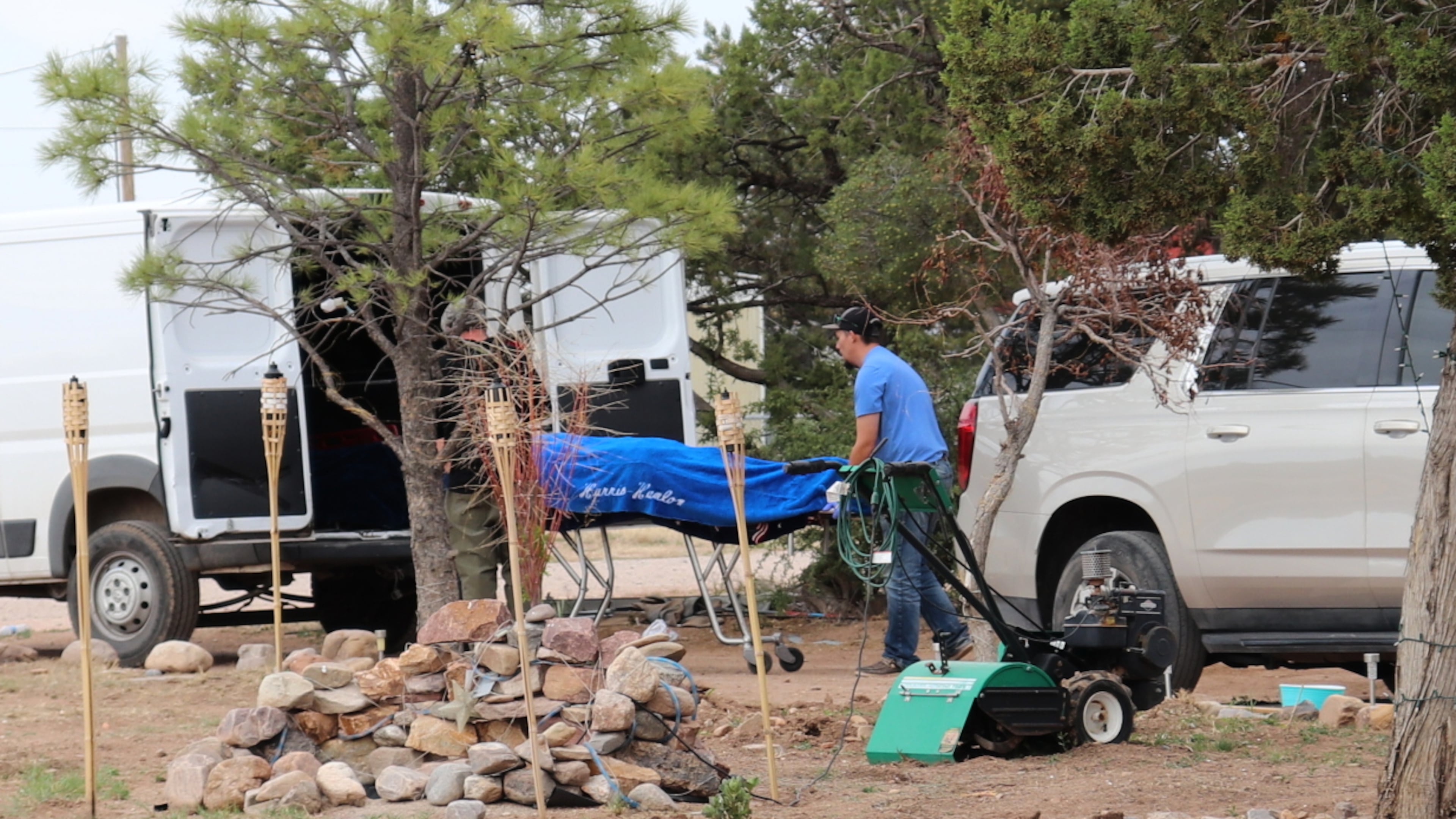 Workers remove a body in Mountainair, N.M., Wednesday, May 20, 2026, after several people died and more than a dozen first responders were exposed to an unknown substance. (AP Photo/Savannah Peters)