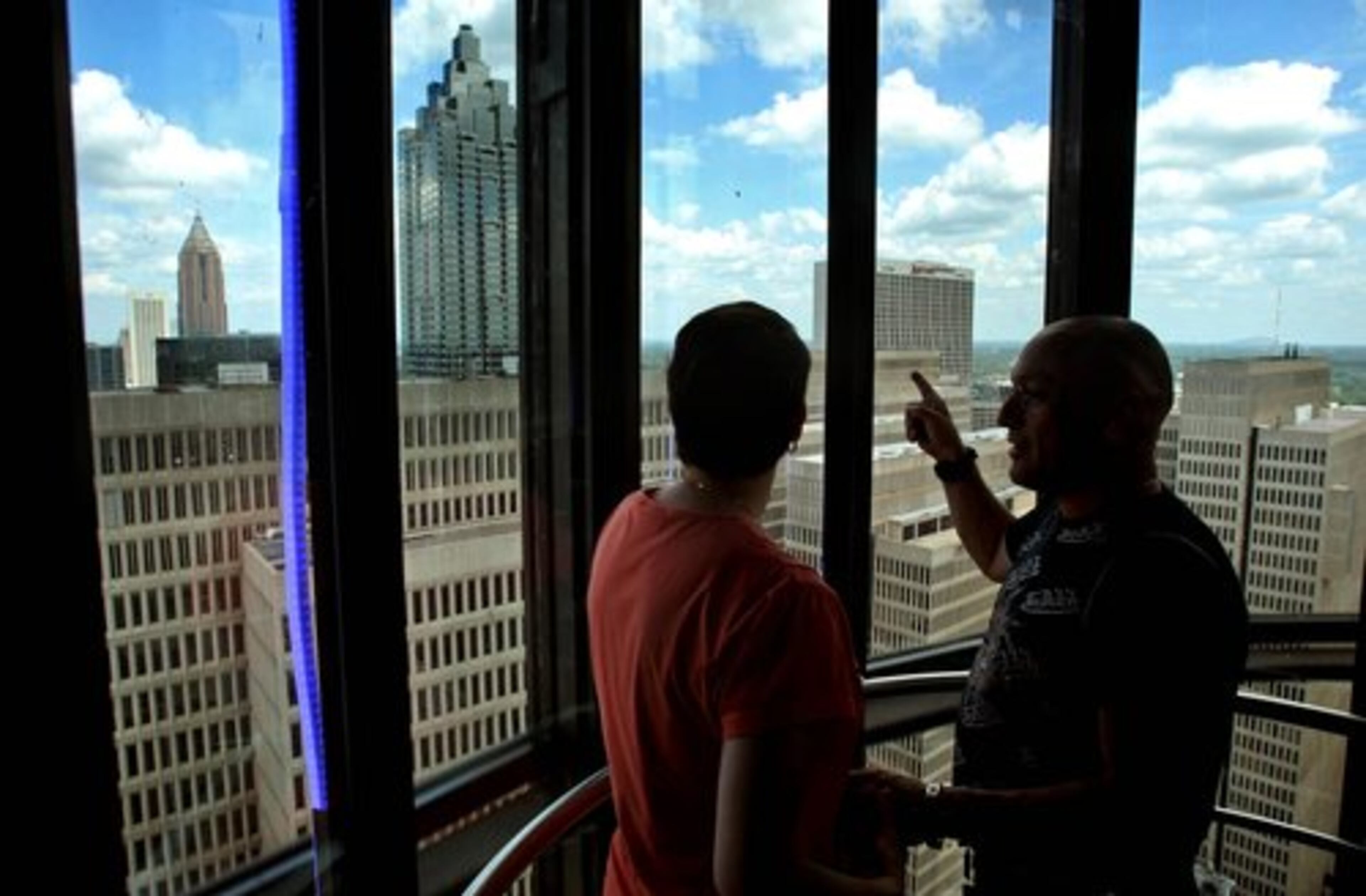 Kandi Darlow, of Dahlonega, left, and Daniel Covi, right, visiting from Sovie, France, enjoy the view as they ride to the top in the scenic elevator.
