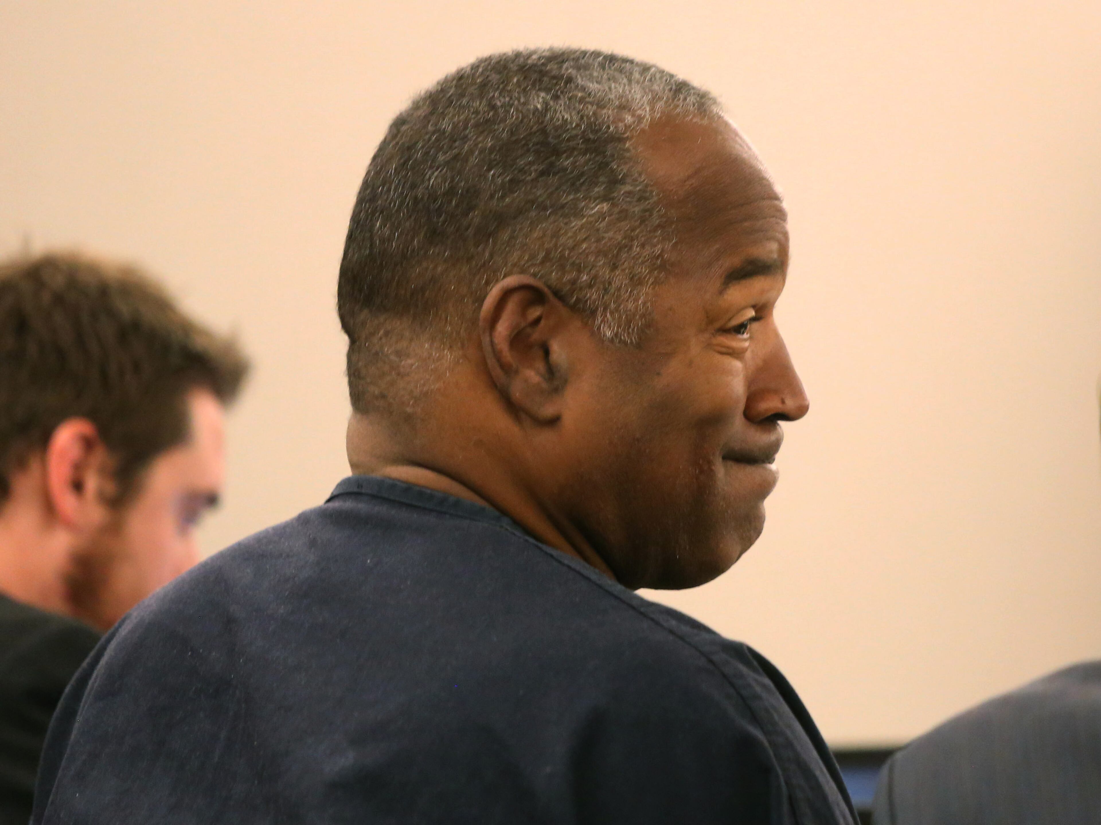 O.J. Simpson smiles in court at Clark County Regional Justice Center in Las Vegas, Monday, May 13, 2013. Simpson, who is currently serving a nine-to-33-year sentence in state prison as a result of his October 2008 conviction on armed robbery and kidnapping charges, is seeking a new trial, claiming that trial lawyer Yale Galanter had conflicted interests and shouldn't have handled Simpson's armed case. (AP Photo/Las Vegas Review-Journal, Jeff Scheid, Pool)