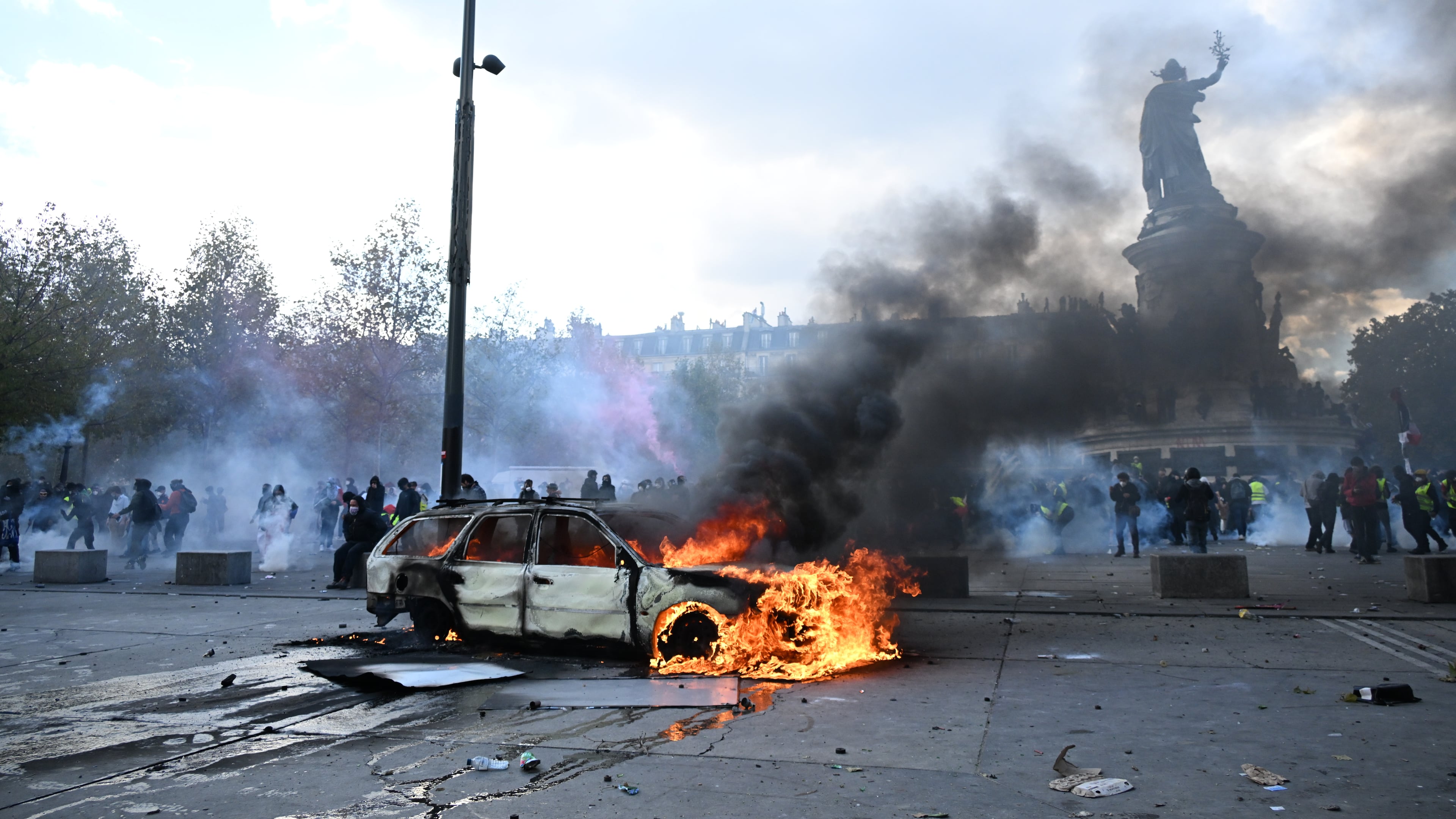 A car burns at Place de La Republique during a protest against rising living costs in Paris, Saturday, Oct. 17, 2026. (AP Photo/Emma Da Silva)