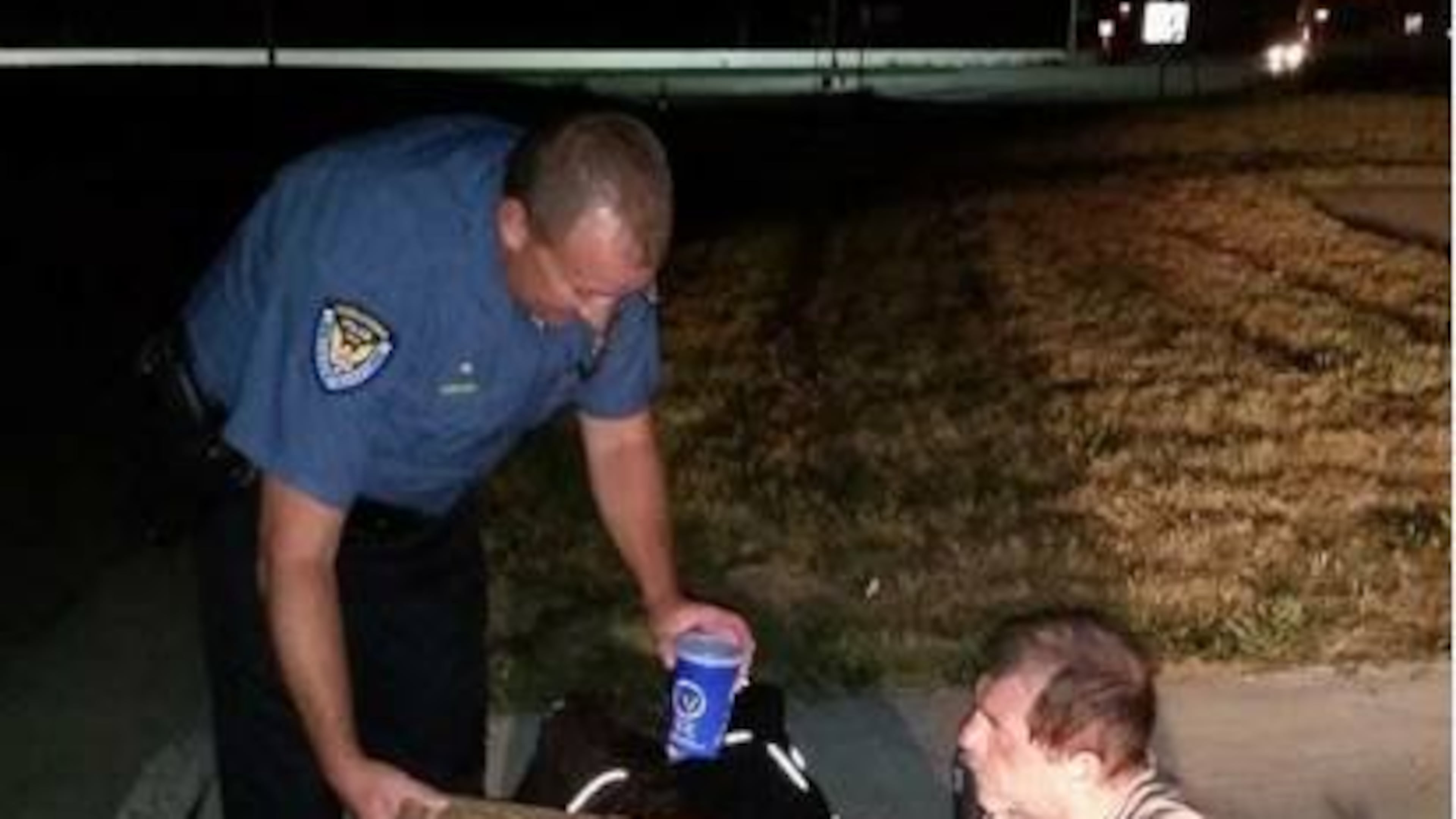 A photo posted to Middletown Division of Police Facebook page showed an officer giving a homeless man a pizza and drink. PHOTO CREDIT: Facebook