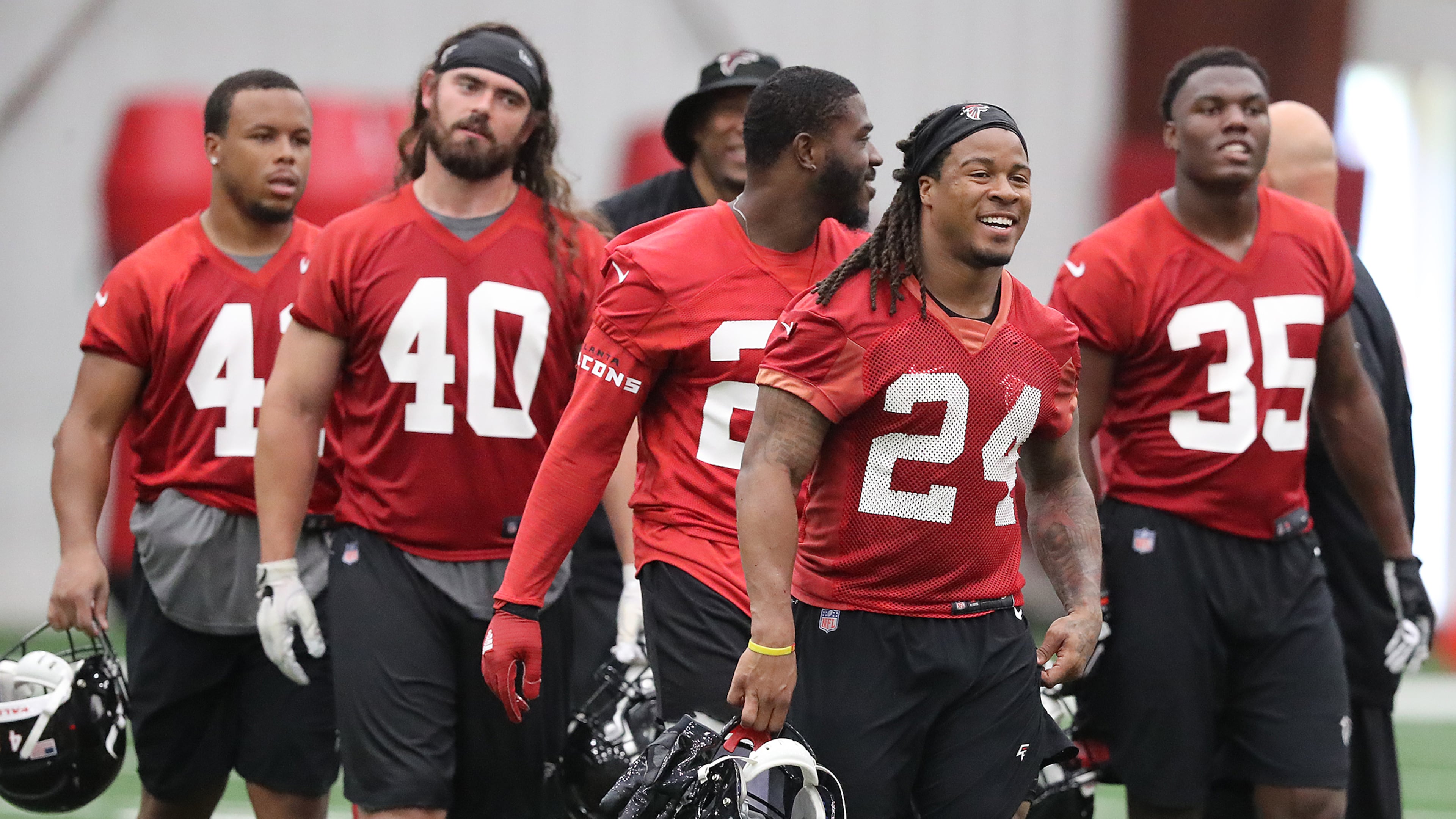 May 22, 2018 Flowery Branch: Atlanta Falcons offensive players Demario Richard (from left), Daniel Marx, Tevin Coleman, Devonta Freeman, and Malik Williams head to the next drill during organized team activities on Tuesday, May 22, 2018, in Flowery Branch. Curtis Compton/ccompton@ajc.com