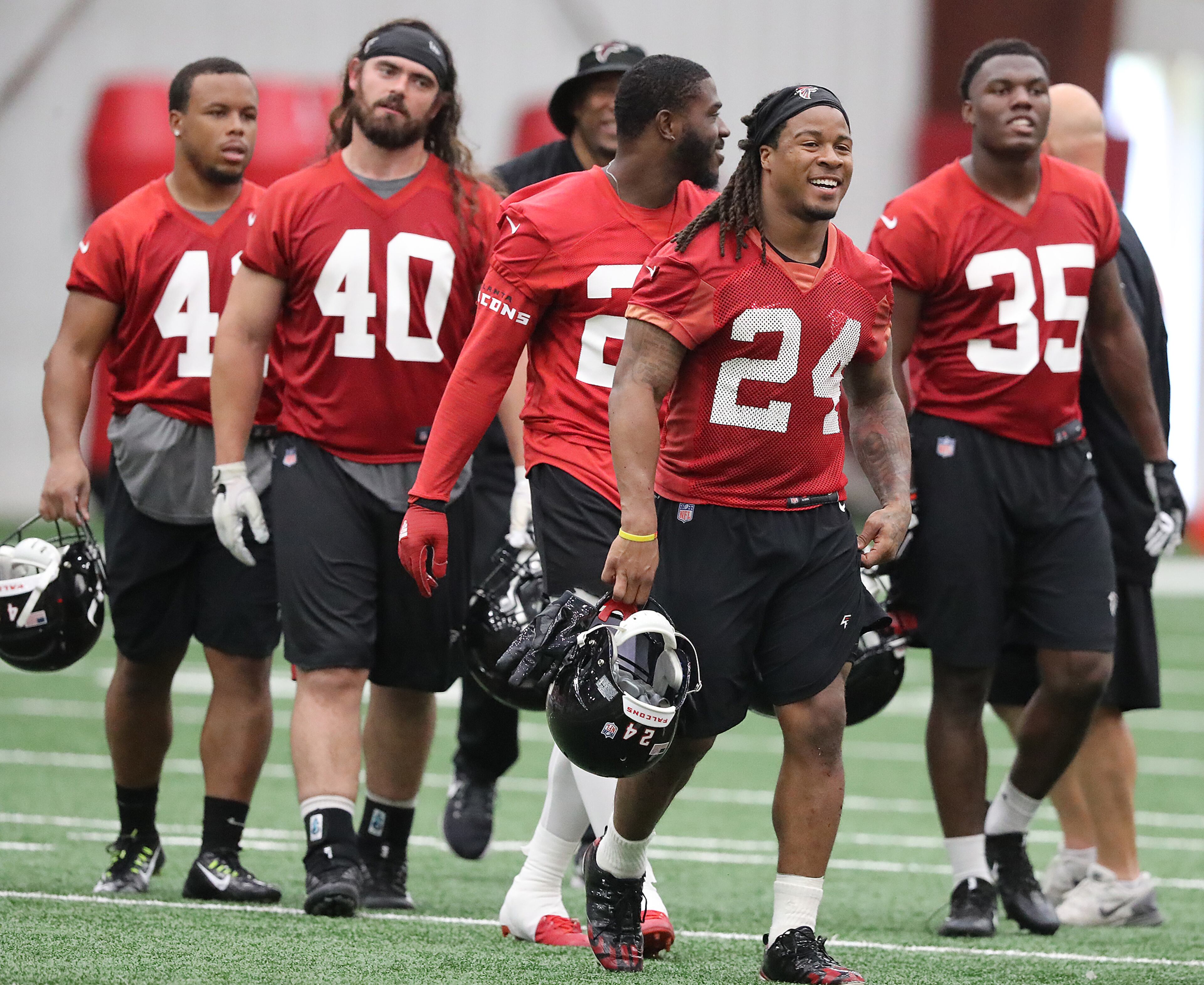 May 22, 2018 Flowery Branch: Atlanta Falcons offensive players Demario Richard (from left), Daniel Marx, Tevin Coleman, Devonta Freeman, and Malik Williams head to the next drill during organized team activities on Tuesday, May 22, 2018, in Flowery Branch. Curtis Compton/ccompton@ajc.com