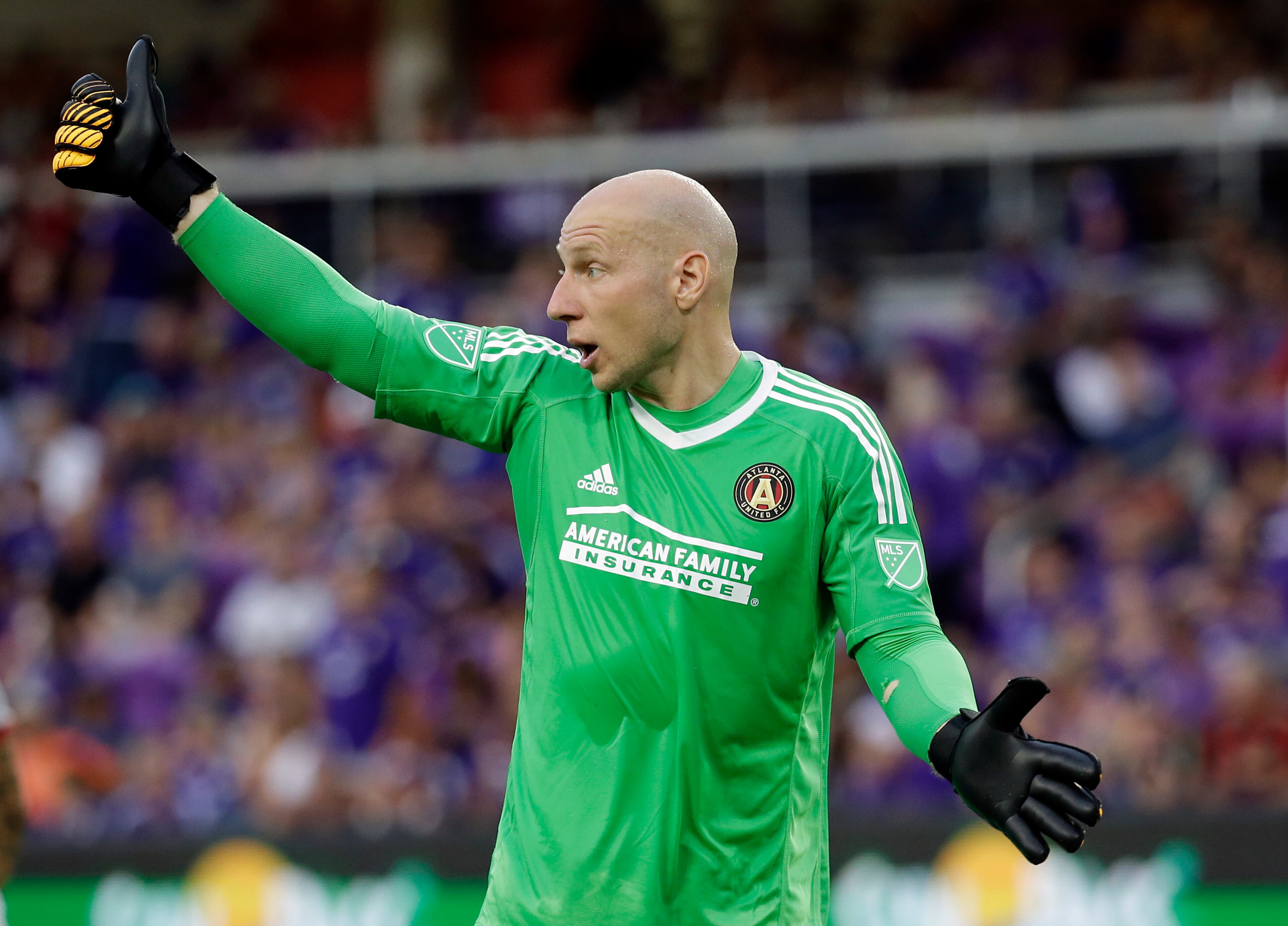 Atlanta United goalkeeper Brad Guzan gestures to a teammate during the first half of an MLS soccer match against Orlando City, Friday, July 21, 2017, in Orlando, Fla. (AP Photo/John Raoux)