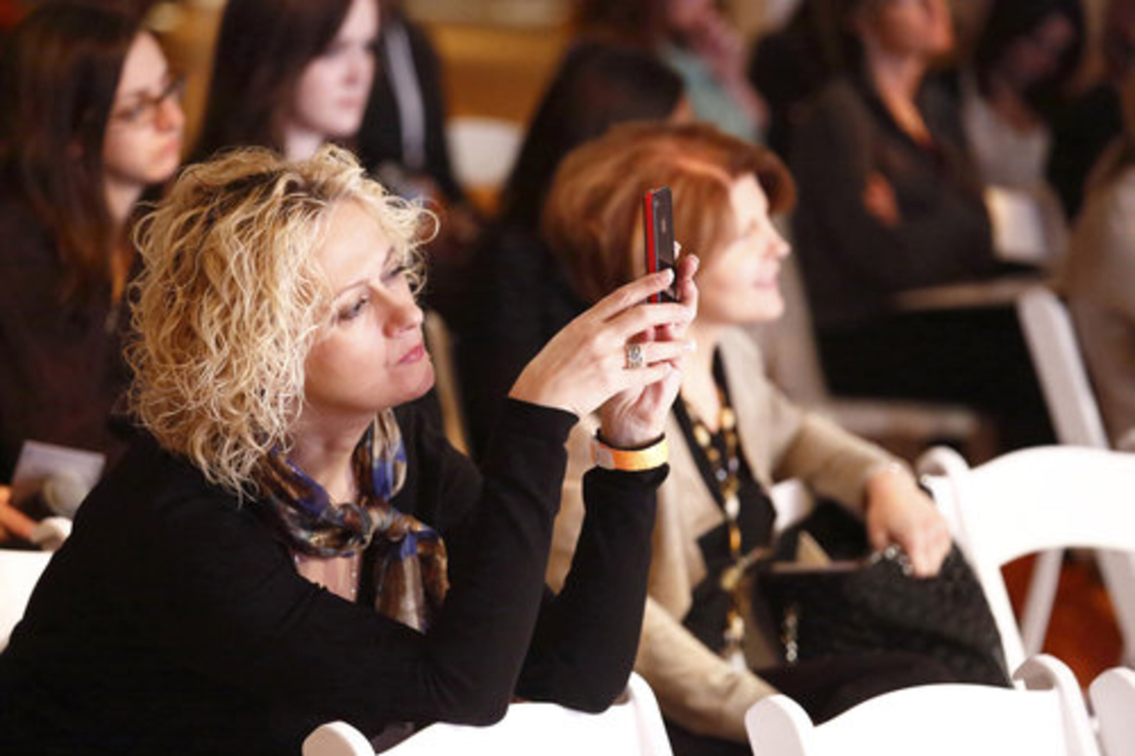 In this March 31, 2012 photo, attendee Diana Polonskaya of the Brooklyn borough of New York, attends a seminar at the Start Over Smart Divorce Expo in New York. A smattering of vendors set up booths offering everything from a divorce planning binder to advice on long-term insurance, with seminars on such topics as "Sensuality Secrets" and "My Formerly Hot Life."