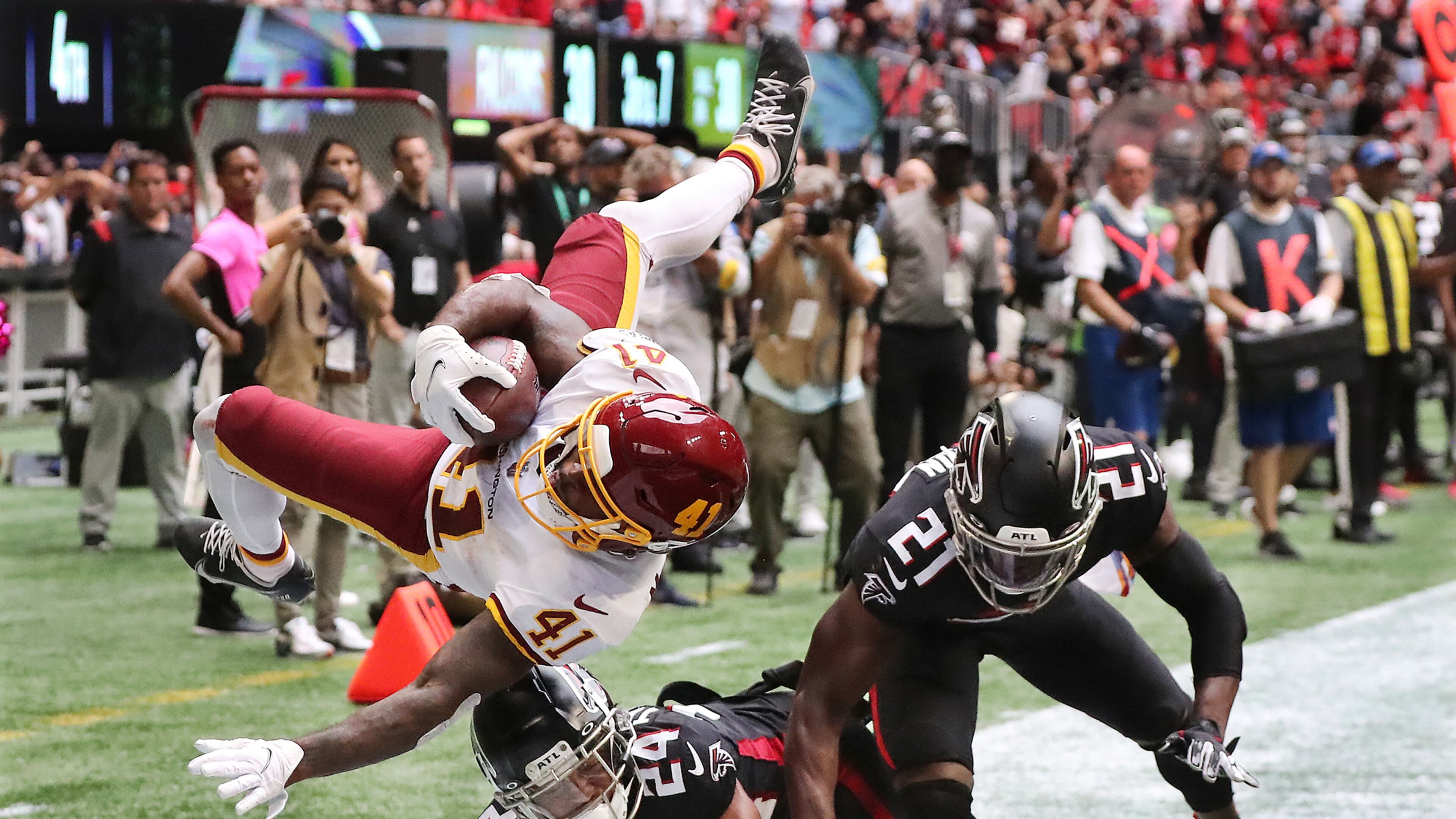 100321 ATLANTA: -- GAME WINNER -- Washington Football Team running back J.D. McKissic gets into the endzone for the game winner with Atlanta Falcons cornerback A.J. Terrell (left) and safety Duron Harmon arriving late with the hit during the final minute for a 34-30 Washington victory over the Falcons in a NFL football game on Sunday, Oct. 3, 2021, in Atlanta. “Curtis Compton / Curtis.Compton@ajc.com”