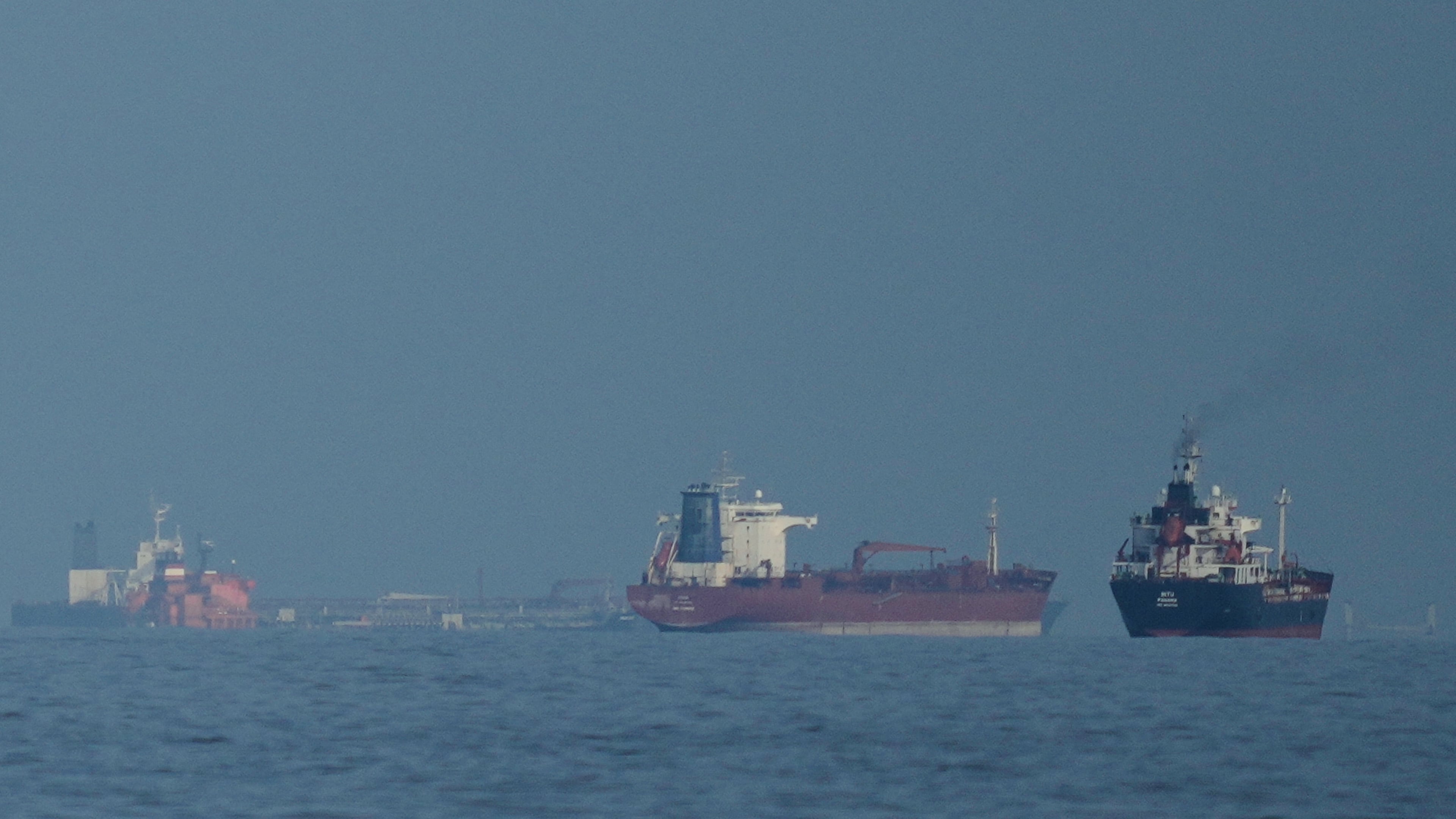 FILE - Oil tankers and cargo ships line up in the Strait of Hormuz as seen from Khor Fakkan, United Arab Emirates, Wednesday, March 11, 2026. (AP Photo/Altaf Qadri,File)