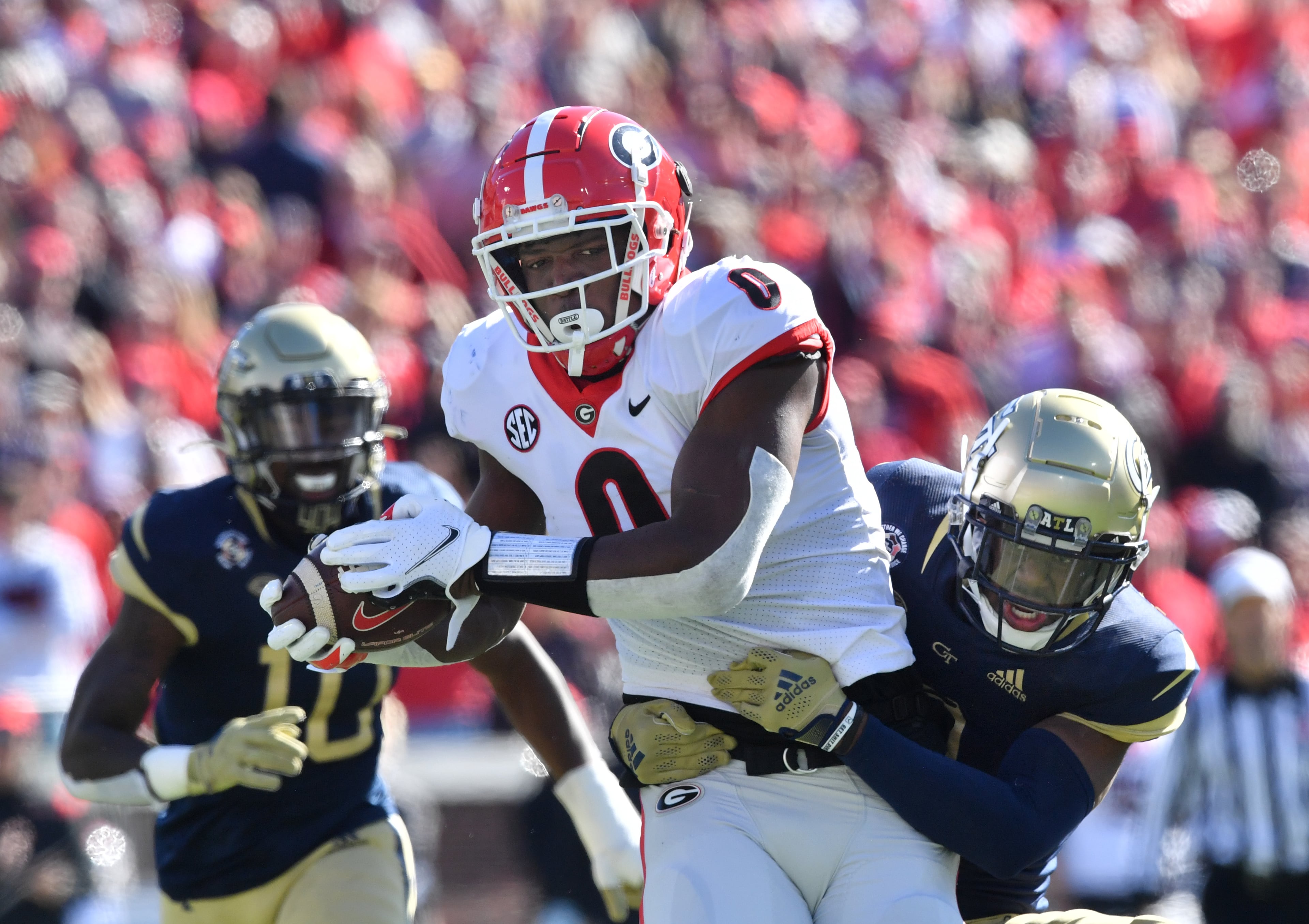 Georgia's tight end Darnell Washington (0) gets tackled behind from Georgia Tech's defensive back Tre Swilling (3) during the first half of an NCAA college football game at Georgia Tech's Bobby Dodd Stadium in Atlanta on Saturday, November 27, 2021. (Hyosub Shin / Hyosub.Shin@ajc.com)
