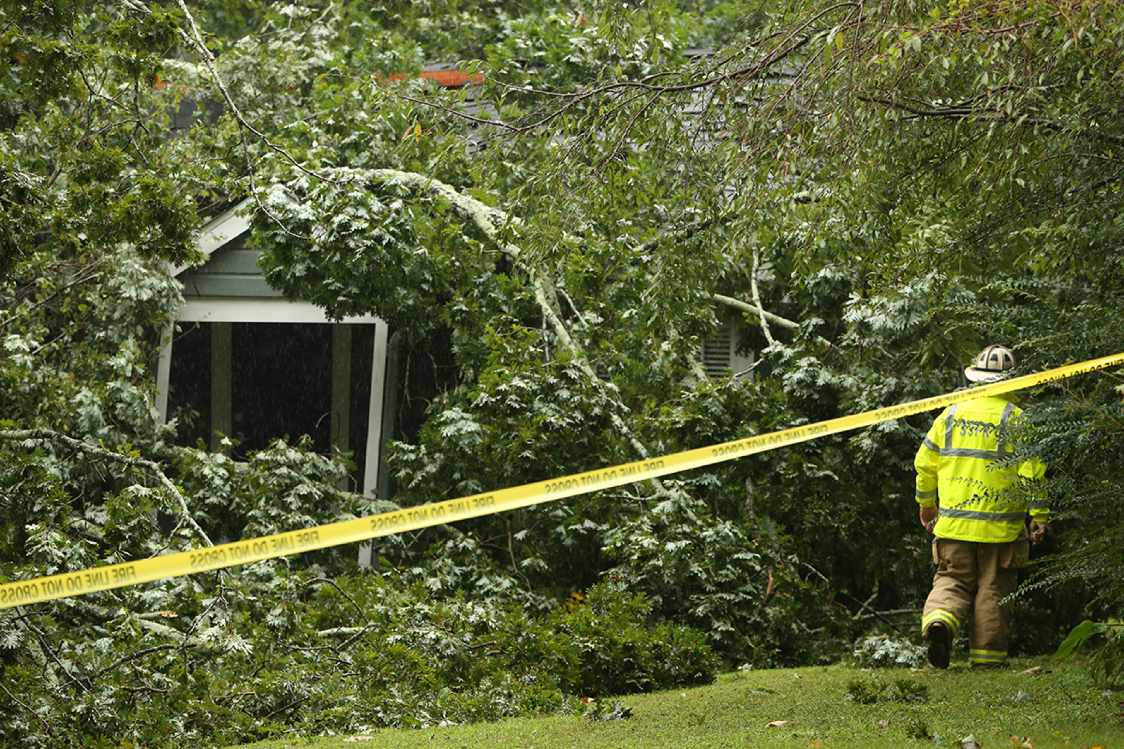 September 11, 2017 - Atlanta, Ga. - A fire fighter walks towards the back of a home that had been destroyed by a collapsing tree on Monday, September 11, 2017. As tropical storm Irma passes through Georgia, it's strong winds and gusts take down trees and power lines all across metro Atlanta. (Photo by Henry Taylor/henrytaylorphoto@gmail.com)