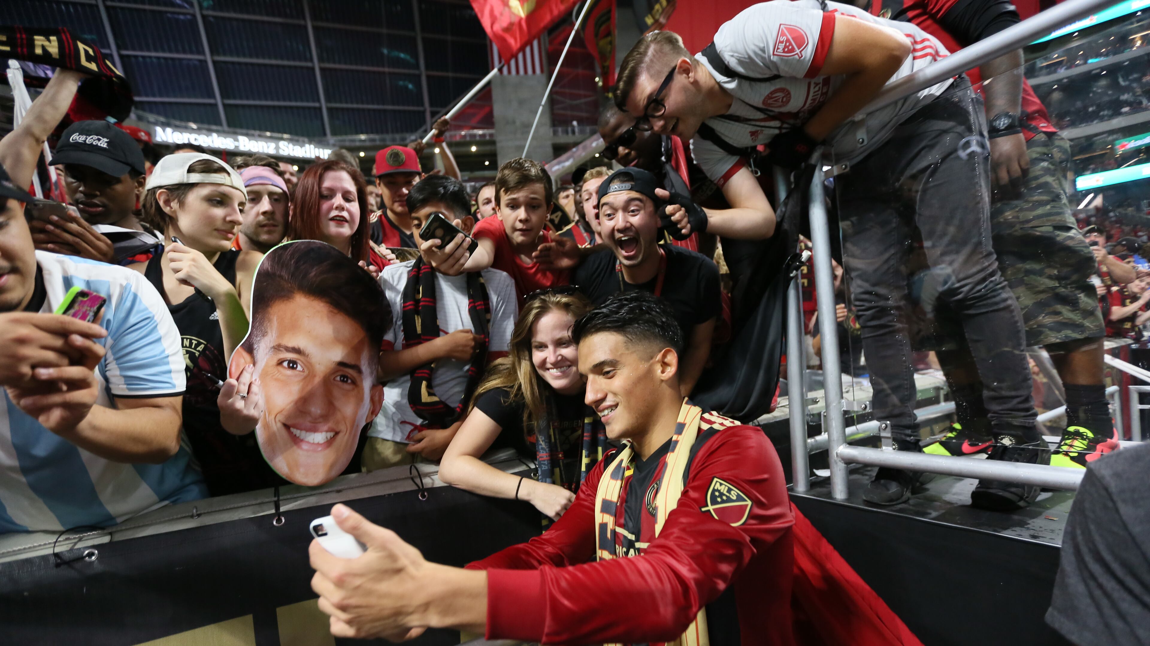Atlanta United midfielder Yamil Azad takes photos with fans
after he was named the man of the match.
