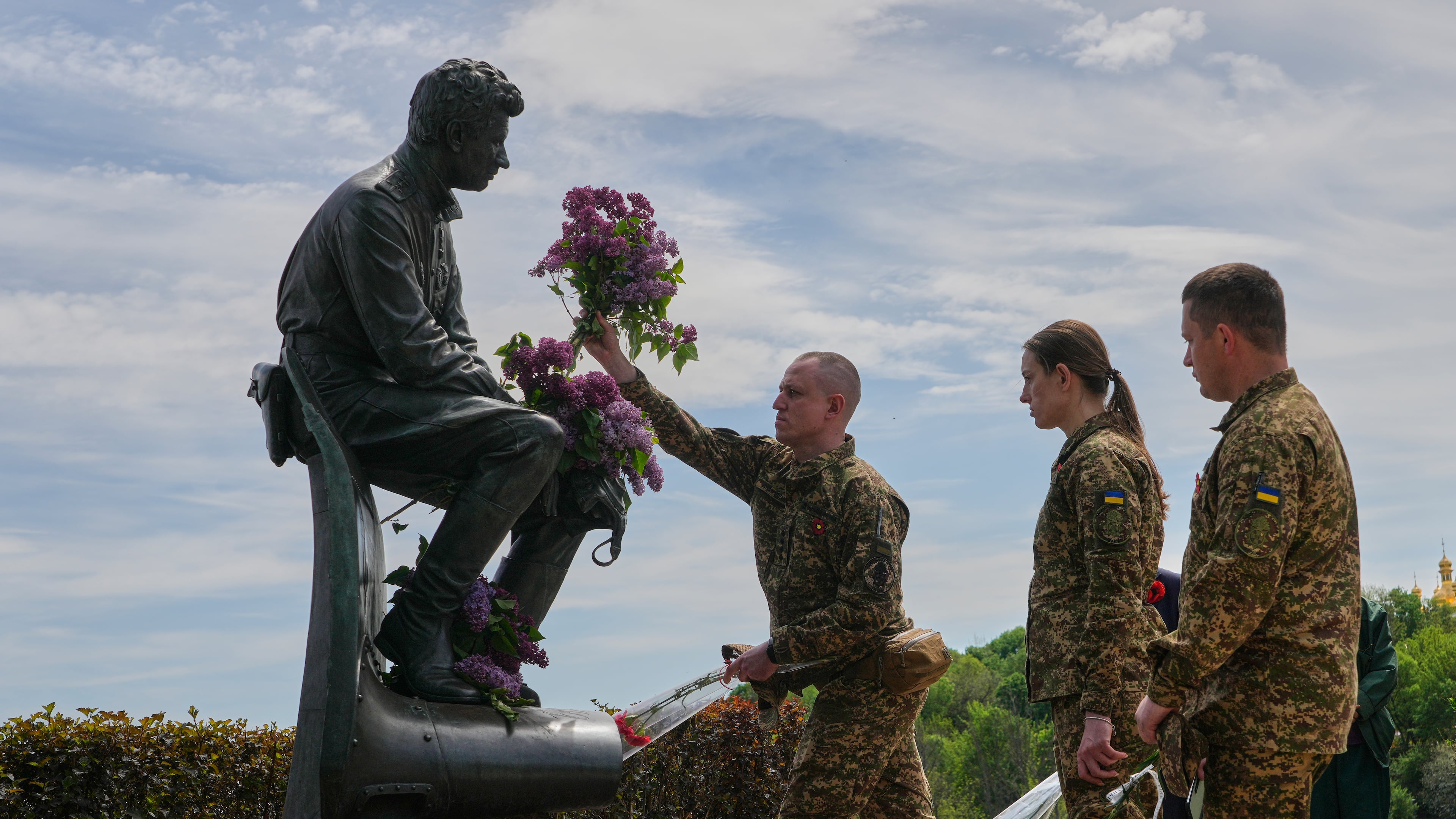 Ukrainian army officers lay flowers at a monument to pilots to mark Victory Day in World War II, in Kyiv, Ukraine, Friday, May 8, 2026, as the Russian attack on Ukraine continues. (AP Photo/Efrem Lukatsky)