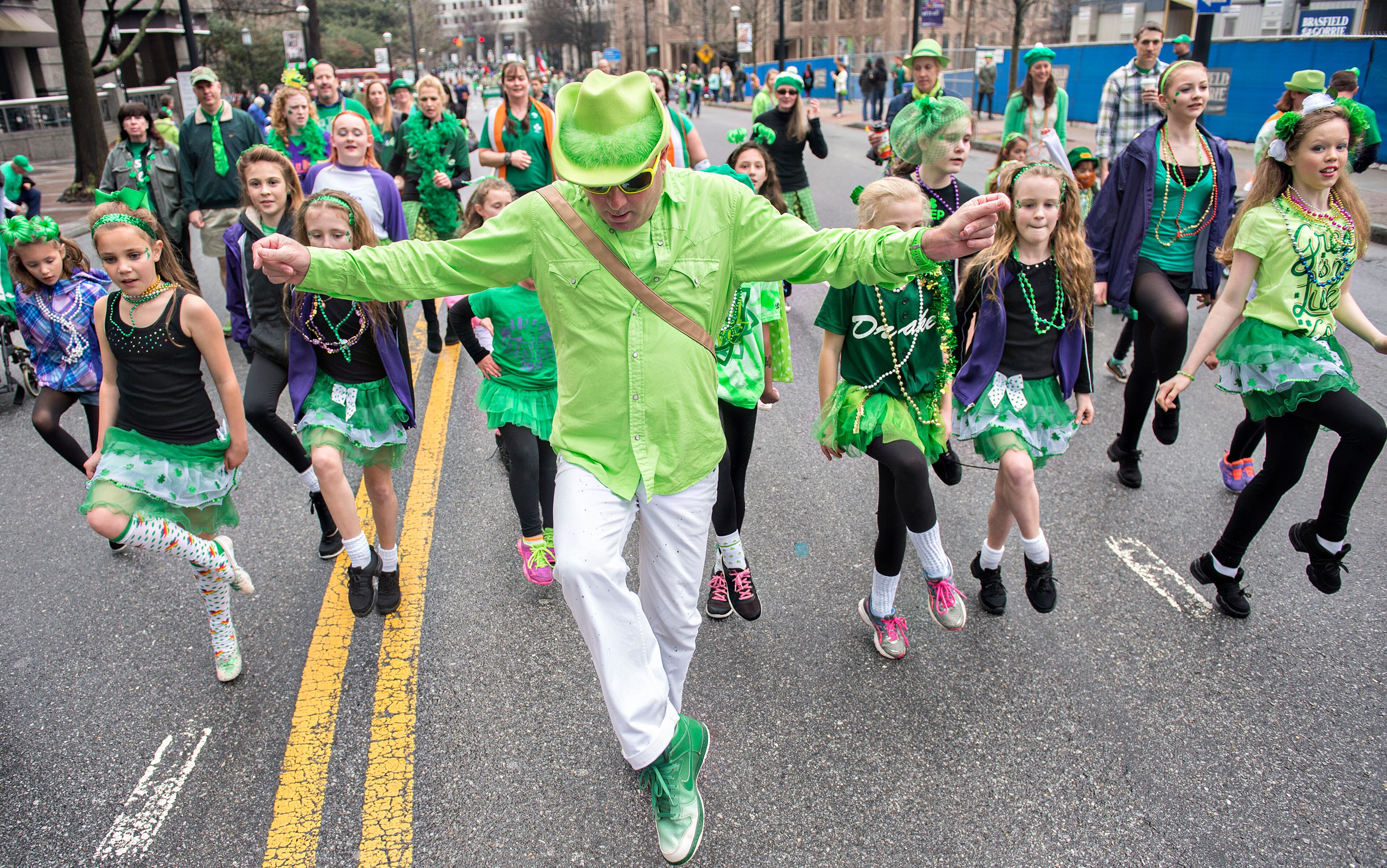 Karl Drake (center) leads his dancers down Peachtree Street during the 2015 Atlanta St. Patrick's Parade on March 14, 2015.
