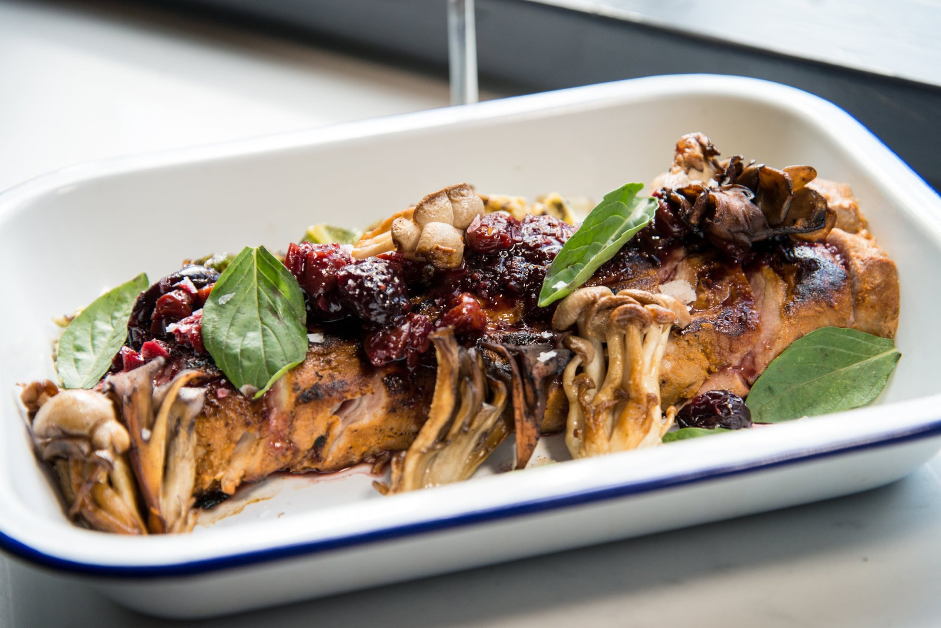 Whiskey Bird Pork Tenderloin with gochujang marinade, braised cabbage, roasted mushrooms, and cherry bourbon mostarda. Photo credit- Mia Yakel.