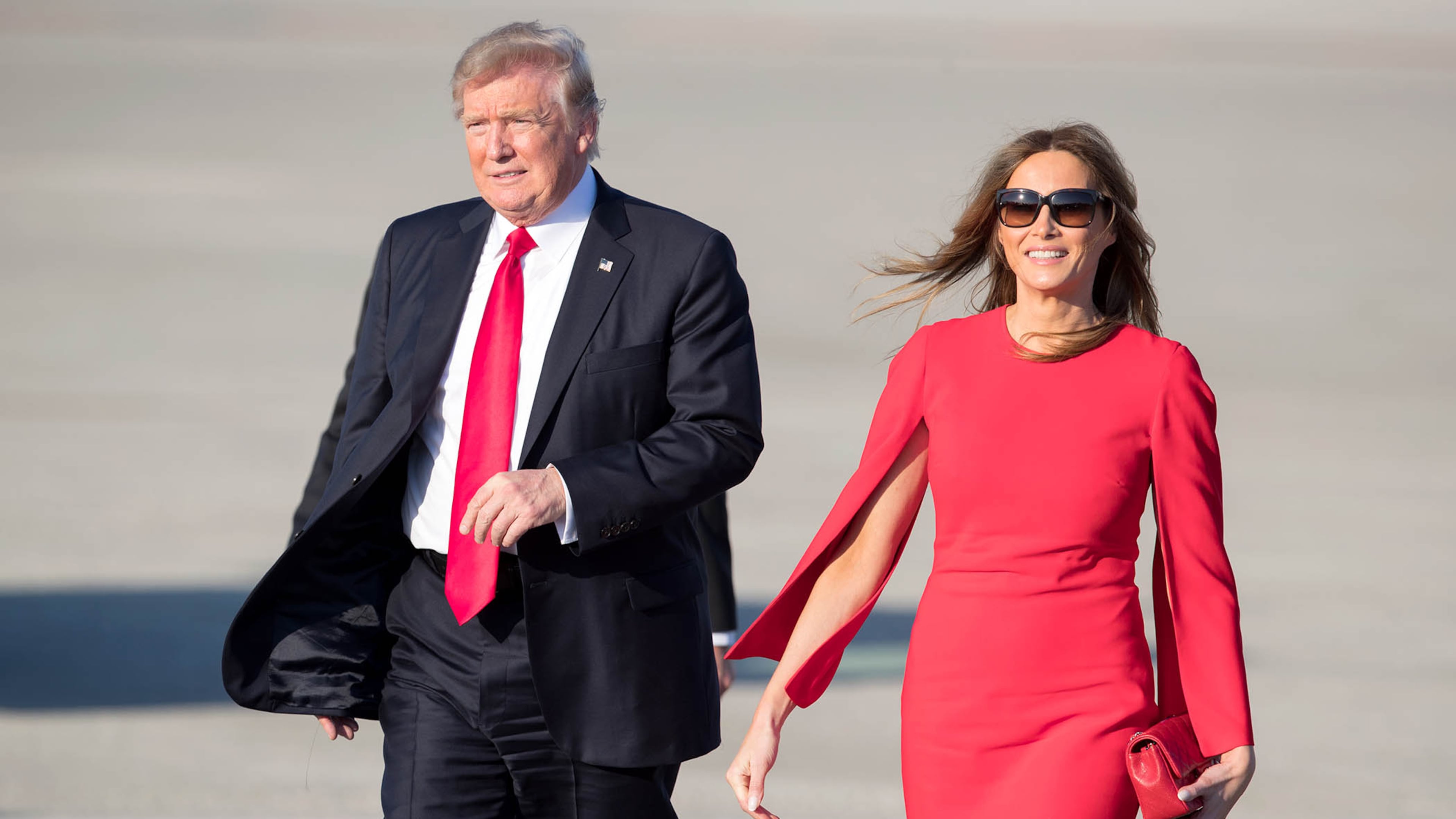 President Donald Trump with his wife, Melania, walk across the tarmac to greet supporters after arriving at Palm Beach International Airport in West Palm Beach on Feb. 3, 2017. Trump will spend the weekend at his Mar-a-Lago estate in Palm Beach. (Allen Eyestone / The Palm Beach Post)
