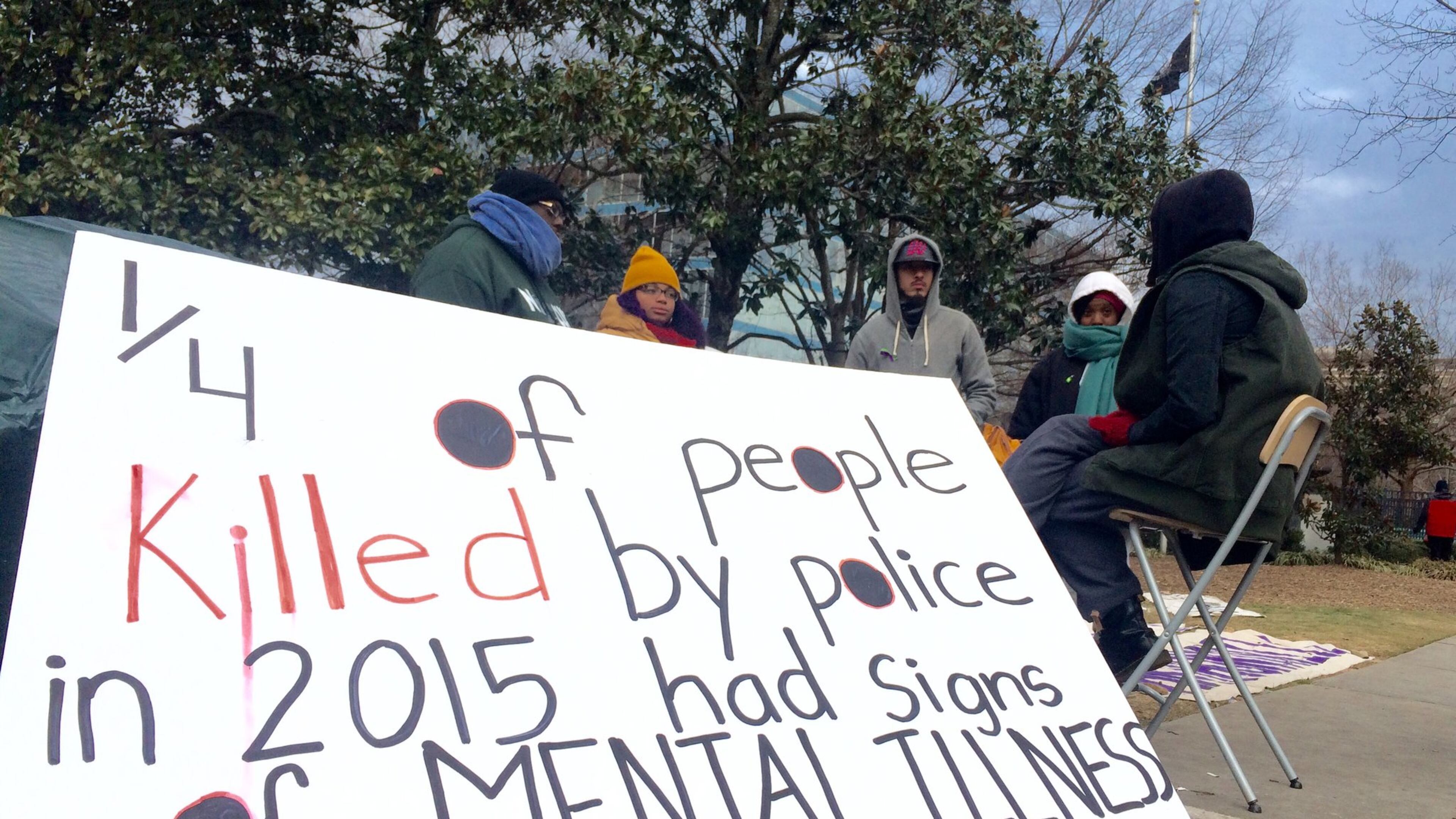A vigil outside the DeKalb County Courthouse, where a grand jury considered whether to indict a DeKalb police officer for the shooting last year of Anthony Hill. A veteran, Hill was naked and unarmed when he was shot and killed. MARK DAVIS/MRDAVIS@AJC.COM