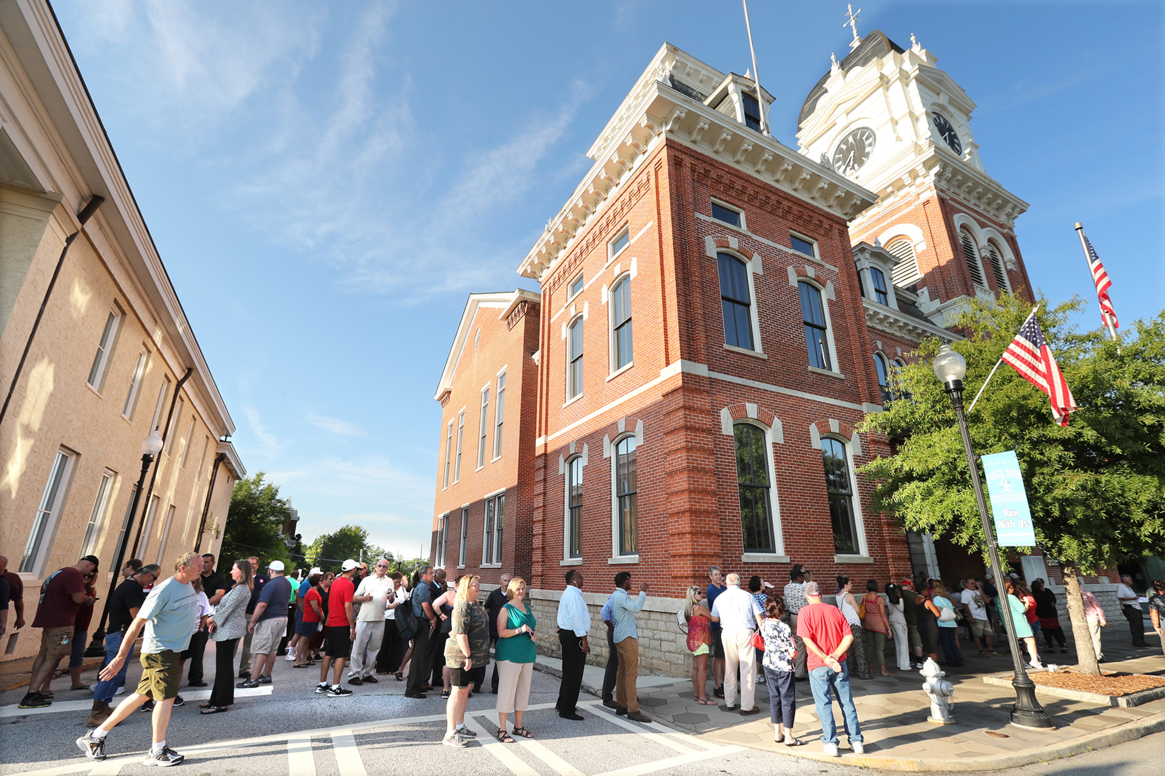 An overflow crowd waits in line outside the historic Newton County courthouse during the first town hall meeting to discuss plans to build a mosque and cemetery in the county on Monday, August 22, 2016, in Covington. The turnout forced the county to hold two meetings back to back to accommodate residents wanting to speak. Curtis Compton /ccompton@ajc.com
