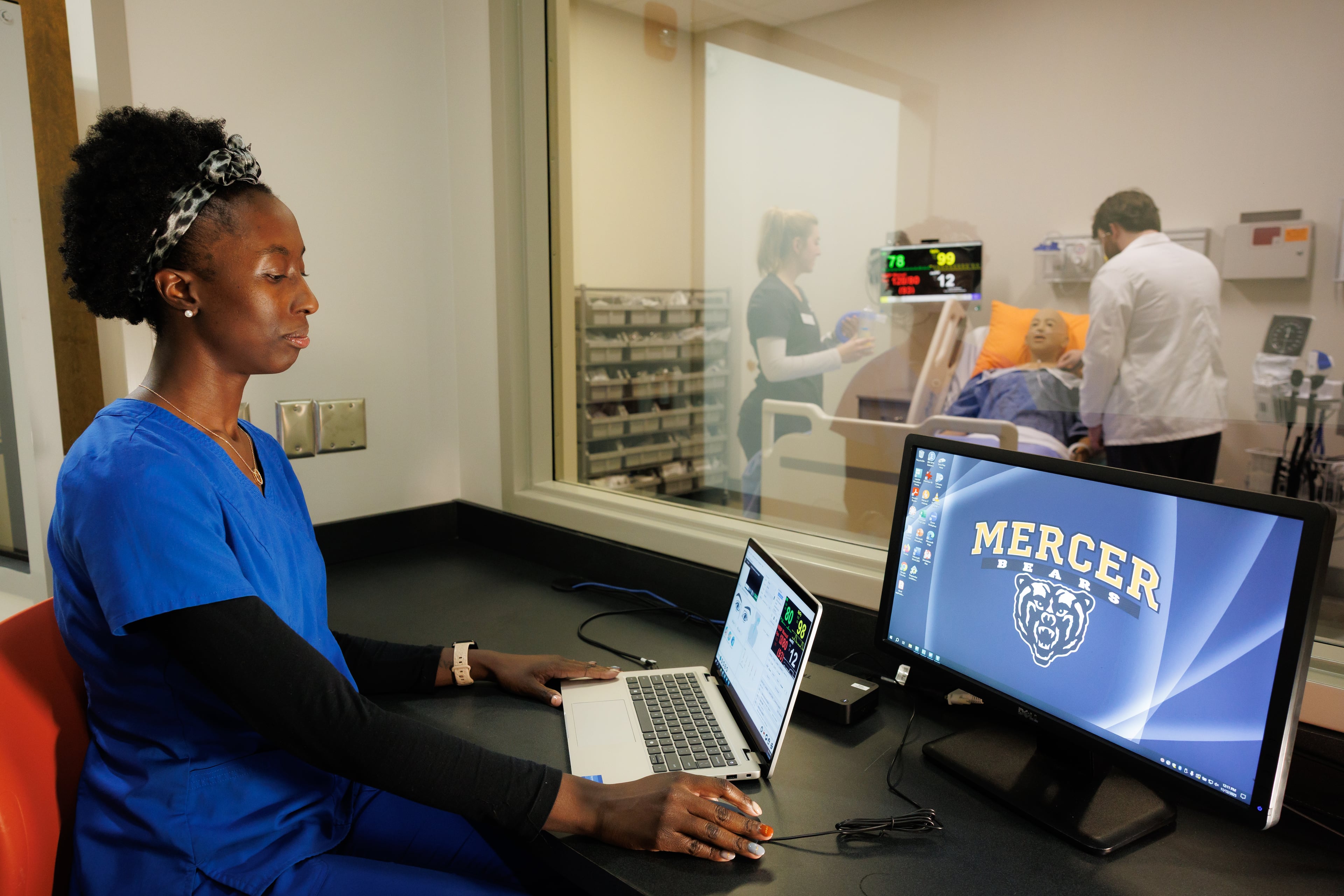 Mercer University nursing students Savelia Howell (left), Sarah Molnar and Wesley Adams participate in a training exercise in the school's simulation lab in Macon. (Courtesy of Leah Yetter)